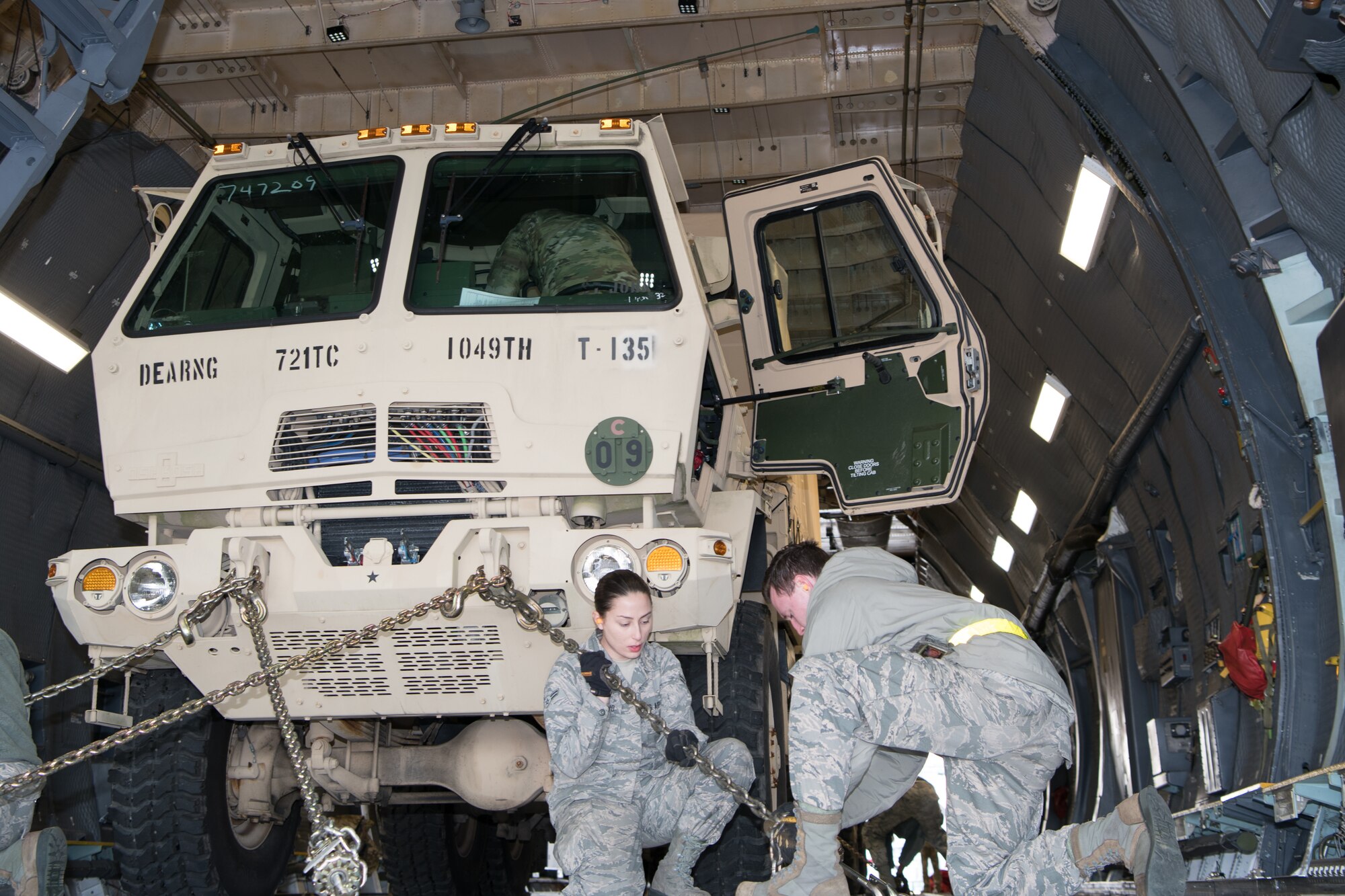 Airmen of the 436th Aerial Port Squadron load and secure vehicles onto a C-5M Super Galaxy during the Dover Operational Readiness for a Multi-domain Agile Response Exercise Nov. 14, 2019, at Dover Air Force Base, Del. Vehicles and personnel from the 72nd Troop Command in New Castle, Del., were used to simulate a mass troop deployment. (U.S. Air Force photo by Mauricio Campino)