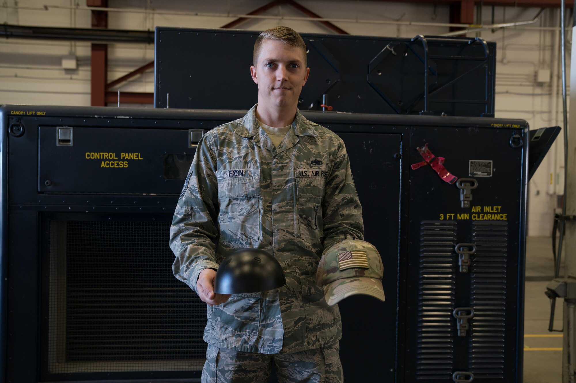 Tech. Sgt. Haisen Exon, 90th Missile Maintenance Squadron, Facilities Maintenance Section, support section NCOIC, shows the bump cap insert and how it inserts into a normal cap on F.E. Warren AFB, Wyoming, Nov. 18, 2019. He teams up with the 90th Missile Wing LaunchWerx agency to bring forward an idea to prevent future head injuries across the wing. (U.S. Air Force photo by Joseph Coslett)