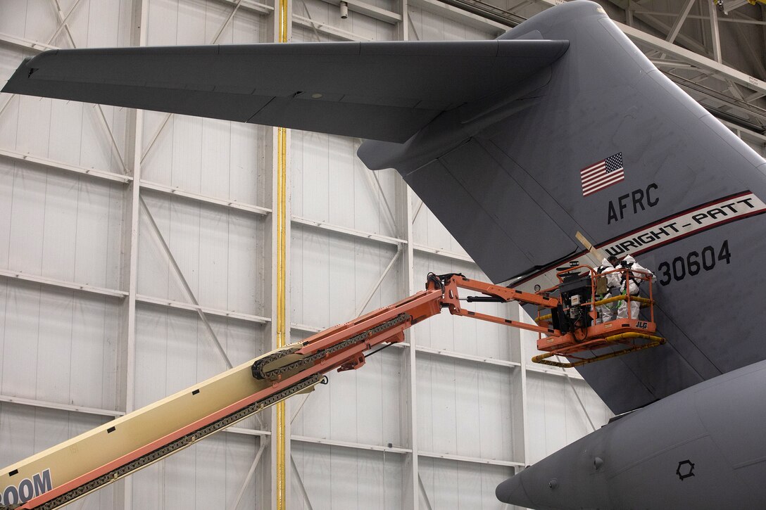 Staff Sgt. Charles Swaim and Senior Airman Clayton Langston, both aircraft structural maintenance technicians with the 445th Maintenance Squadron, spot paint a C-17 Globemaster III during the Oct. 6, 2019 unit training assembly.