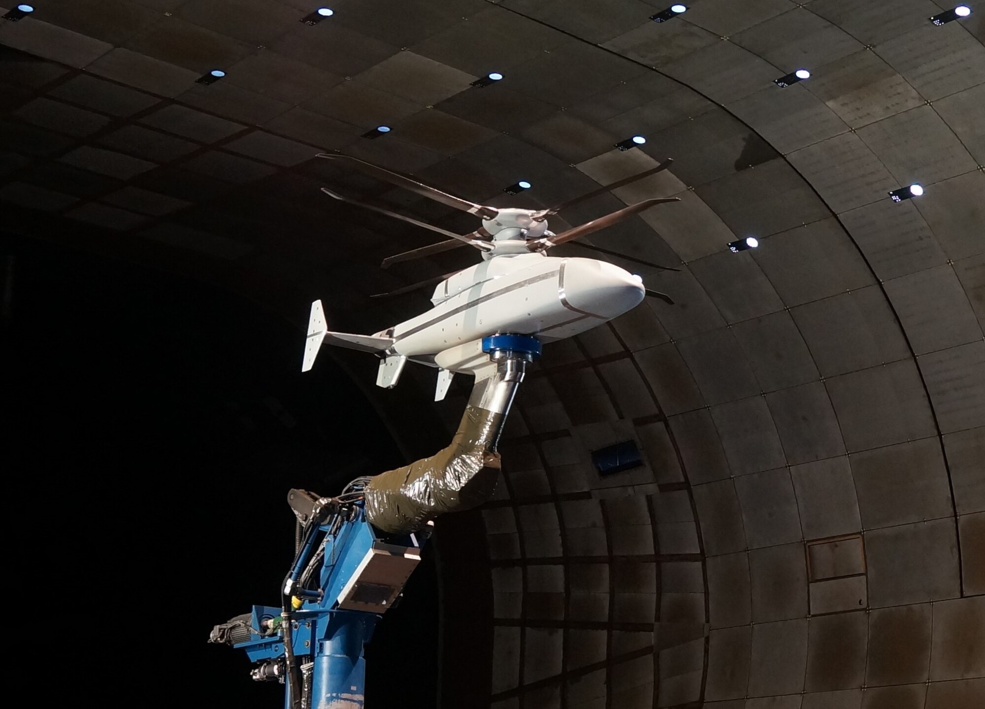 A scale model of the Sikorsky-Boeing SB>1 DEFIANT™ undergoes testing at the AEDC National Full-Scale Aerodynamics Complex at Moffett Field in Mountain View, California. The goal of the wind tunnel test was to validate the aerodynamic performance and flight mechanics of Sikorsky’s X2 Technology™ aircraft. These configurations, which are being utilized on the SB>1 DEFIANT™, include a lift-offset coaxial rotor system, composite fuselage and rear-mounted pusher propulsor that provides increased speed. (Courtesy photo)
