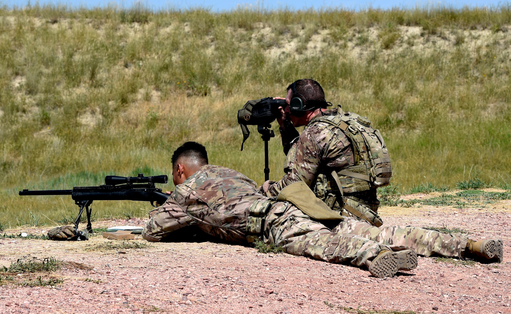 Staff Sgt. Justin McMahon, 90th Missile Security Forces Squadron flight security controller, assures the shooter, Senior Airman Jonne Cadua, 90th Security Support Squadron tactical response force assaulter, is on target during the 2019 Global Strike Challenge, Aug. 7, 2019, at Camp Guernsey, Wyo. Global Strike Challenge is the world’s premiere bomber, ICBM, helicopter operations and security forces competition. (U.S. Air Force photo by Tech Sgt. Tyler Placie)