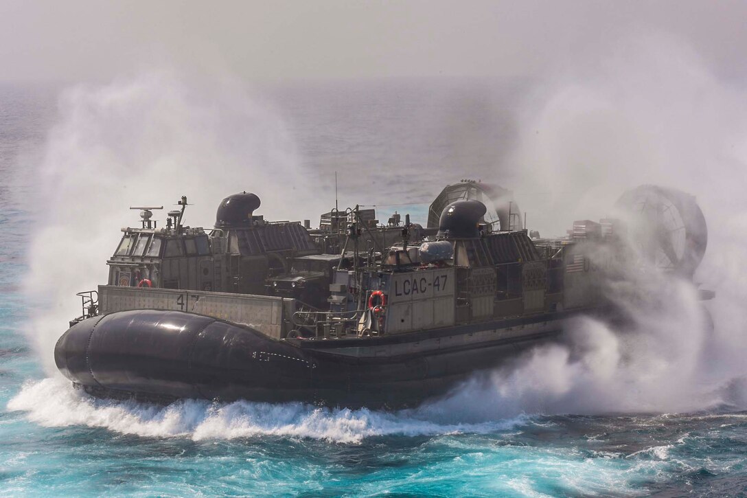 A Navy air-cushioned landing craft transits waters.