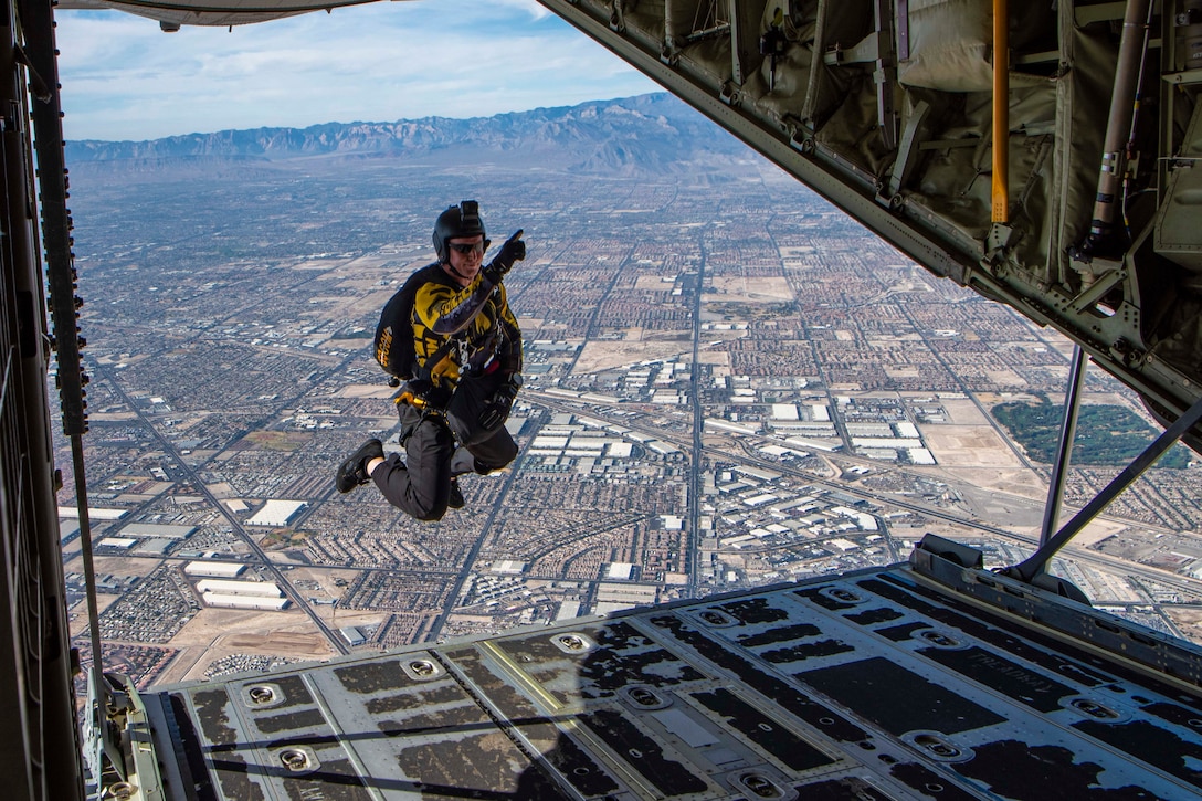 An airman jumps out of a plane.