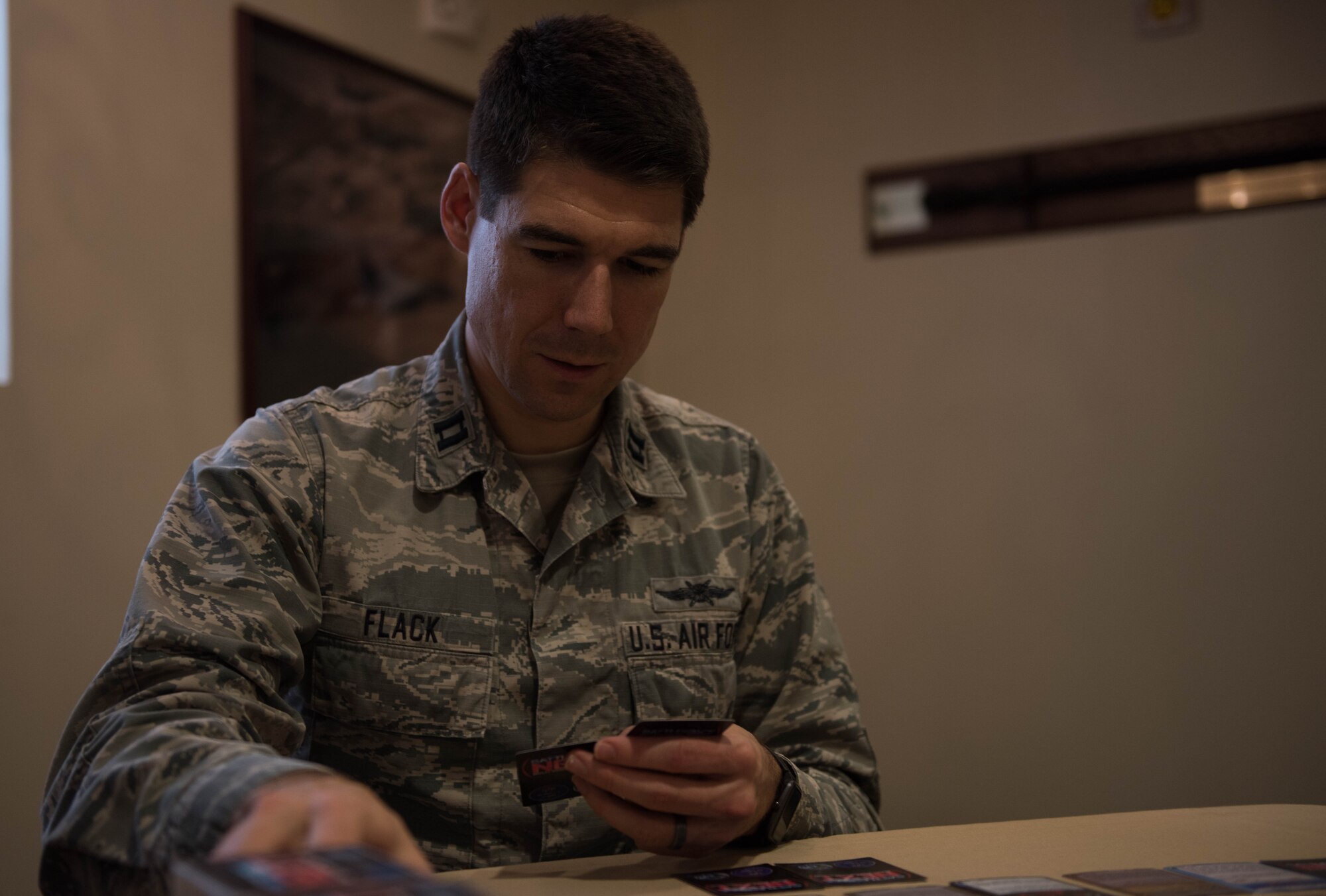 U.S. Air Force Capt. Nathaniel Flack, Department of Electrical and computer engineering student at the Air Force Institute of Technology, lays down a Battlespace Next card at Joint Base Langley-Eustis, Virginia, Nov. 18, 2019. Flack created the game to improve training within the Air Force. (U.S. Air Force photo by Airman 1st Class Sarah Dowe)