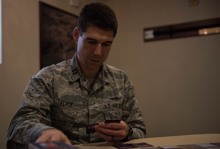 U.S. Air Force Capt. Nathaniel Flack, Department of Electrical and computer engineering student at the Air Force Institute of Technology, lays down a Battlespace Next card at Joint Base Langley-Eustis, Virginia, Nov. 18, 2019. Flack created the game to improve training within the Air Force. (U.S. Air Force photo by Airman 1st Class Sarah Dowe)