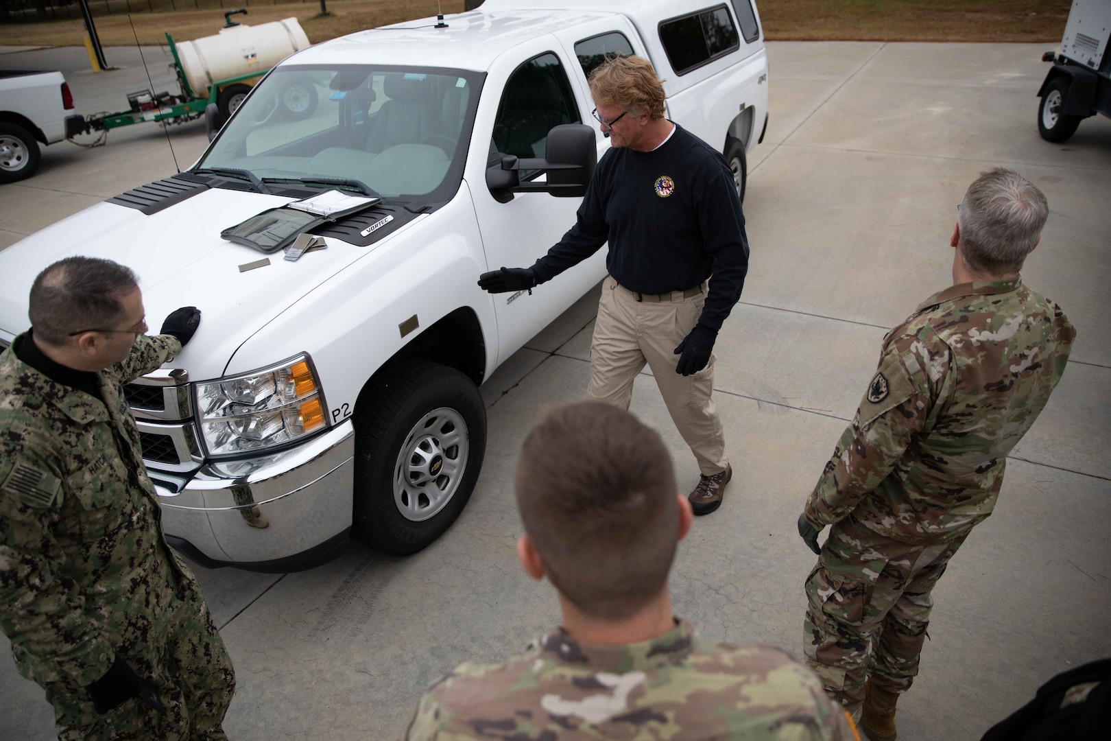 Joint Task Force Civil Support (JTF-CS) Joint Movement Center Chief Tim Fahey explains parking procedures onboard a mock C-17 aircraft as part of aircraft load training. JTF-CS holds this type of training at least once quarterly to build personnel proficiency and confidence in aircraft loading procedures. (DoD photo by Chief Mass Communication Specialist Barry Riley/RELEASED)