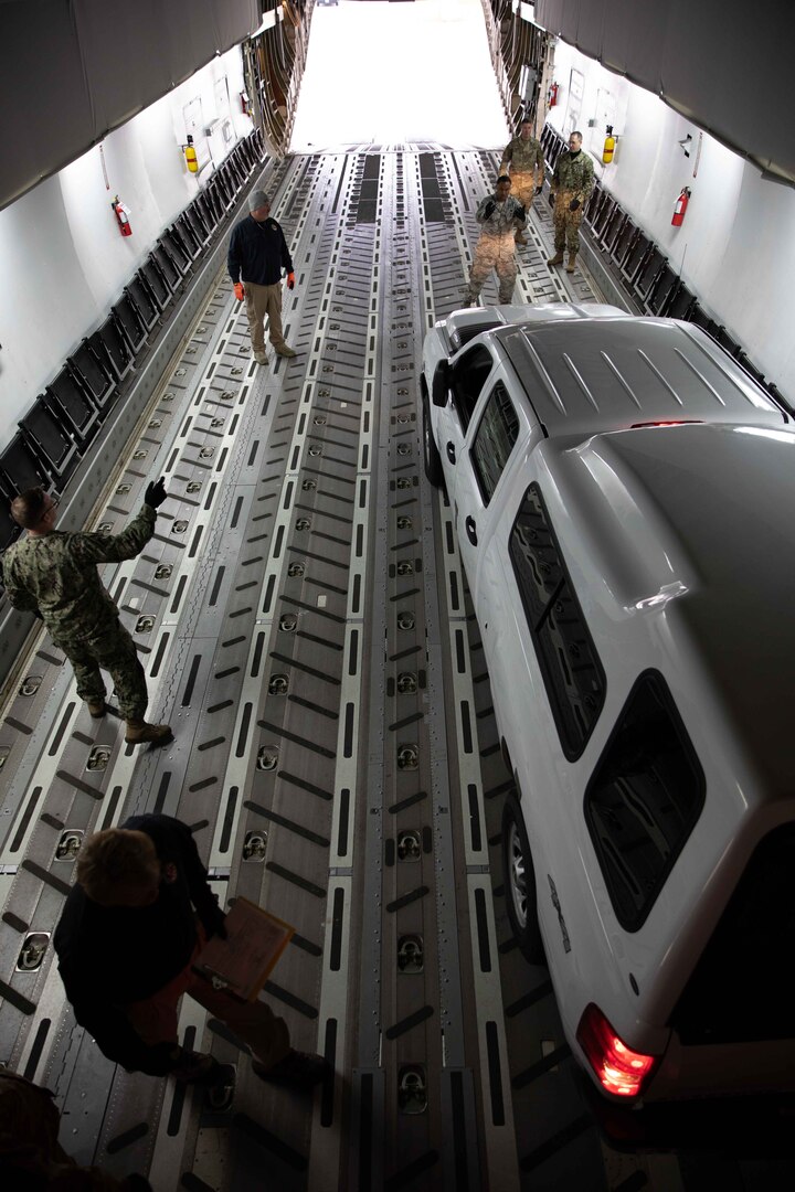 Joint Task Force Civil Support (JTF-CS) members park a pickup truck on a mock C-17 aircraft as part of aircraft load training. JTF-CS holds this type of training at least once quarterly to build personnel proficiency and confidence in aircraft loading procedures in case of a deployment. (DoD photo by Chief Mass Communication Specialist Barry Riley/RELEASED)