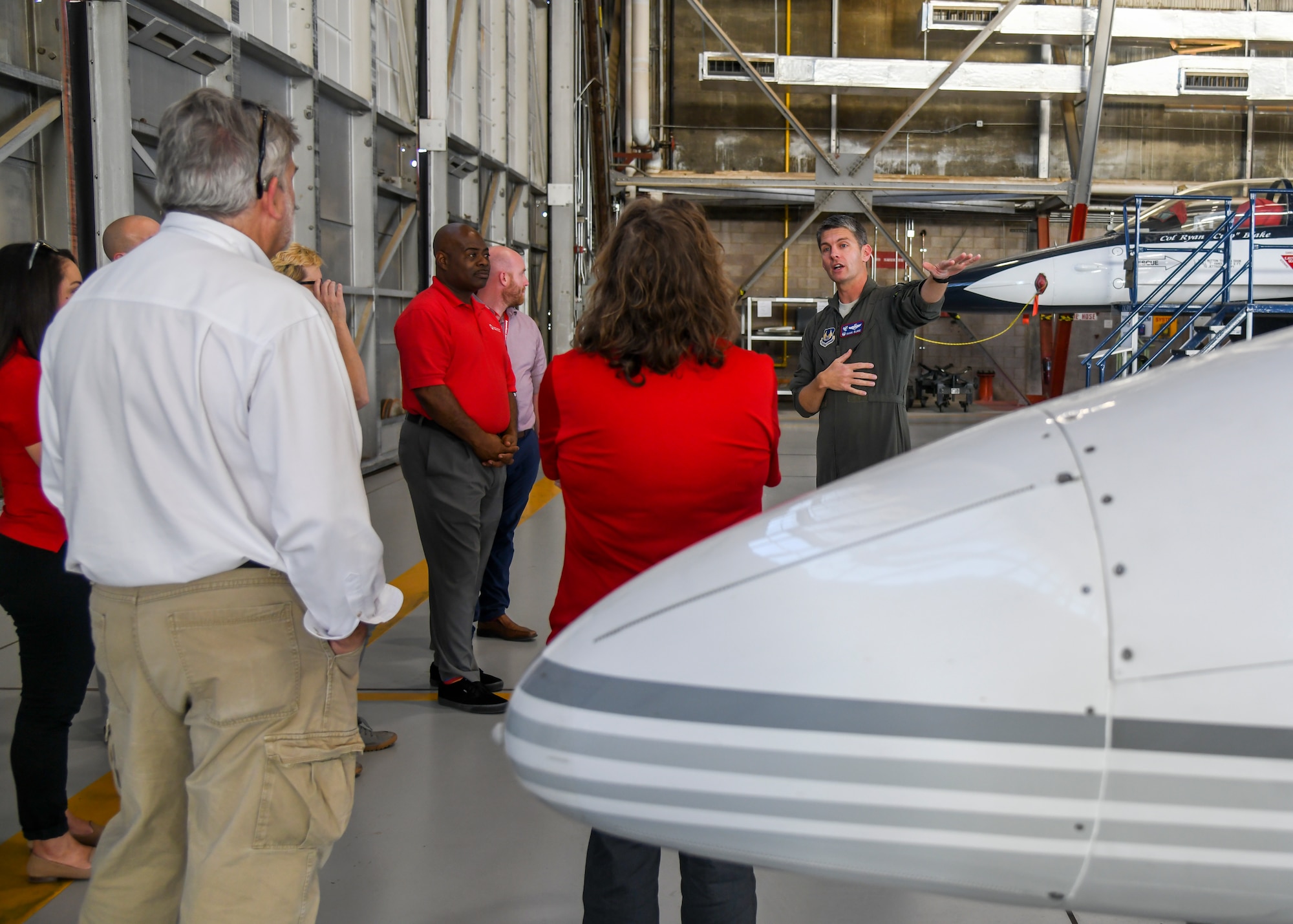 Col. Ryan Blake, Air Force Test Pilot School Commandant, provides a brief on variable stability aircraft used as part of schools's curriculum to members of the Central California and Los Angeles regional offices of the American Red Cross during their visit to Edwards Air Force Base, California, Nov. 18. (Air Force photo by Giancarlo Casem)