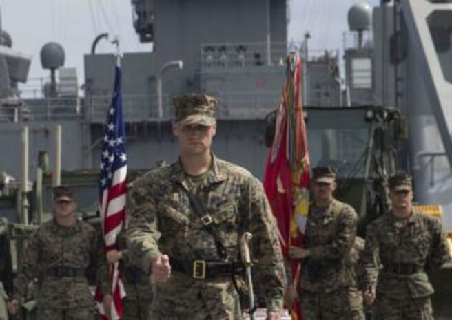 1st Lt. Michael Vazquez, with Combat Logistics Battalion 11, marches to the center of the flight deck of the USS Harpers Ferry.
