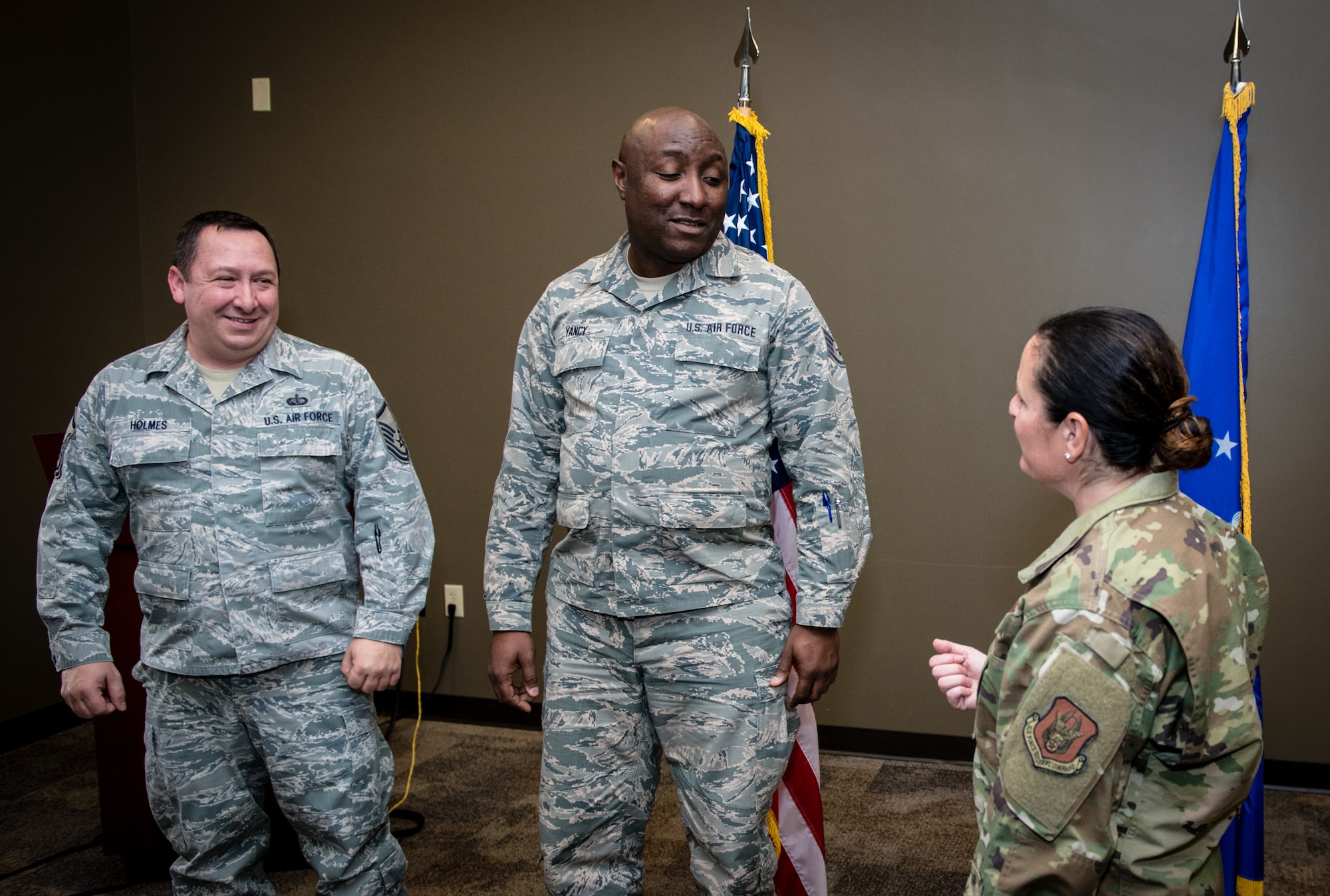 Retiring 932nd Force Support Squadron members, Master Sgt. Jeffery Holmes, left, and Staff Sgt. Germaine Yancy are thanked for their years of service during a combined coin presentation by 932nd Command Chief Barbara Gilmore, Nov. 16, 2019, Scott Air Force Base, Illinois.  Between Holmes and Yancy they have more than 54 years of military service, with Yancy having served in the Marines, Navy, Illinois Army National Guard and the Air Force Reserve. (U.S. Air Force photo by Master Sgt. Christopher Parr)