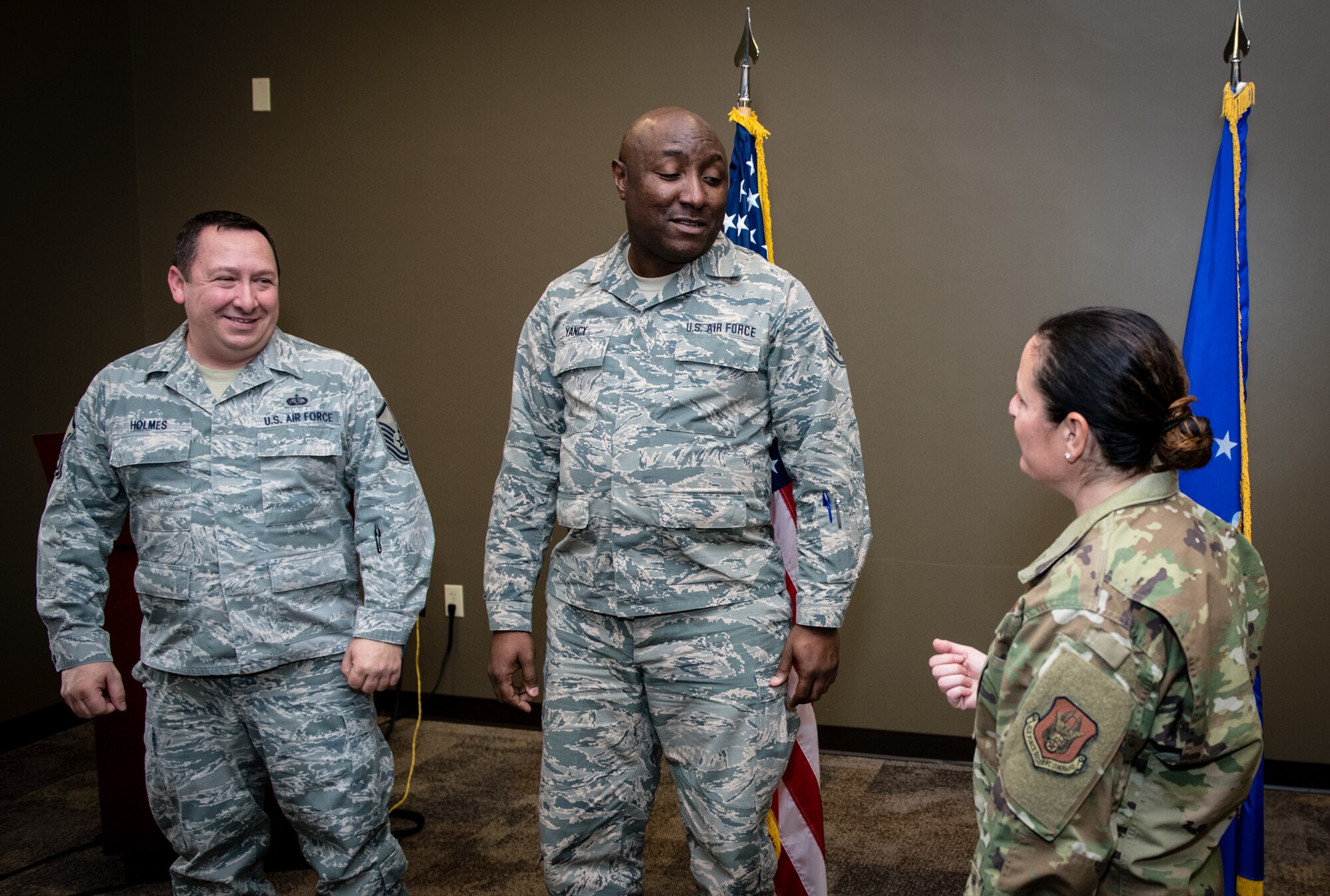 Retiring 932nd Force Support Squadron members, Master Sgt. Jeffery Holmes, left, and Staff Sgt. Germaine Yancy are thanked for their years of service during a combined coin presentation by 932nd Command Chief Barbara Gilmore, Nov. 16, 2019, Scott Air Force Base, Illinois.  Between Holmes and Yancy they have more than 54 years of military service, with Yancy having served in the Marines, Navy, Illinois Army National Guard and the Air Force Reserve. (U.S. Air Force photo by Master Sgt. Christopher Parr)
