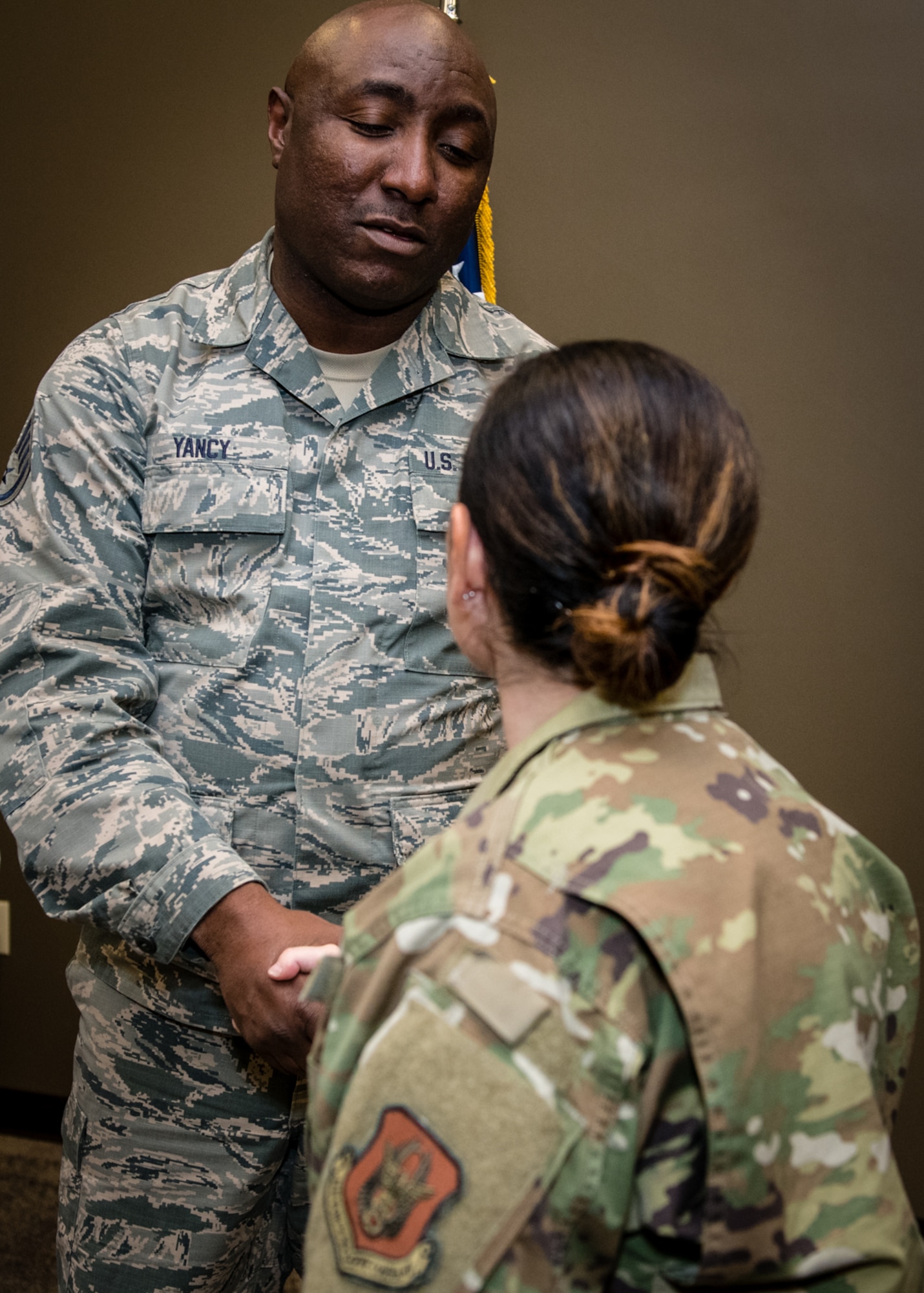 Retiring 932nd Force Support Squadron Services NCO, Staff Sgt. Germaine Yancy is thanked for his years of service during a coin presentation by 932nd Command Chief Barbara Gilmore, Nov. 16, 2019, Scott Air Force Base, Illinois. Yancy spent more than 28 years in the Marines, Navy, Air National Guard and always wanted to finish his career here at Scott Air Force Base. (U.S. Air Force photo by Master Sgt. Christopher Parr)