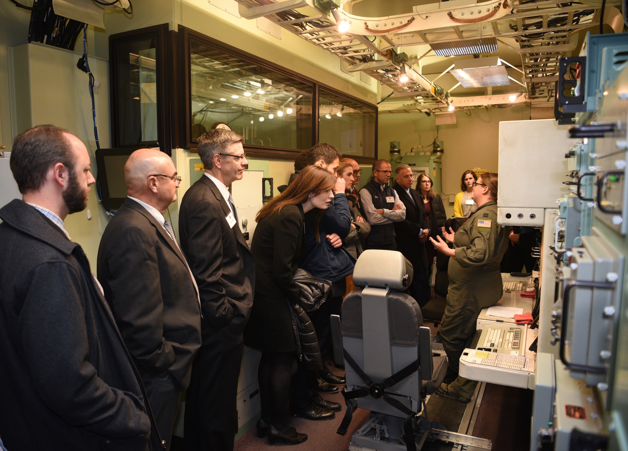 Capt. Amanda Schuyler from the 90th Operations Support Squadron, explains the Missile Procedures Trainers to a visiting group from the local chapter of the American Inns of Court during a tour on base Nov. 7, 2019, on F. E. Warren Air Force Base, Wyo. Members of the Inns of Court included justices from the state supreme court, law professors from the University of Wyoming, and local attorneys. The tour was intended to promote stronger relationships between the base legal professionals and their local civilian counterparts. (U.S. Air Force photo by Glenn S. Robertson).
