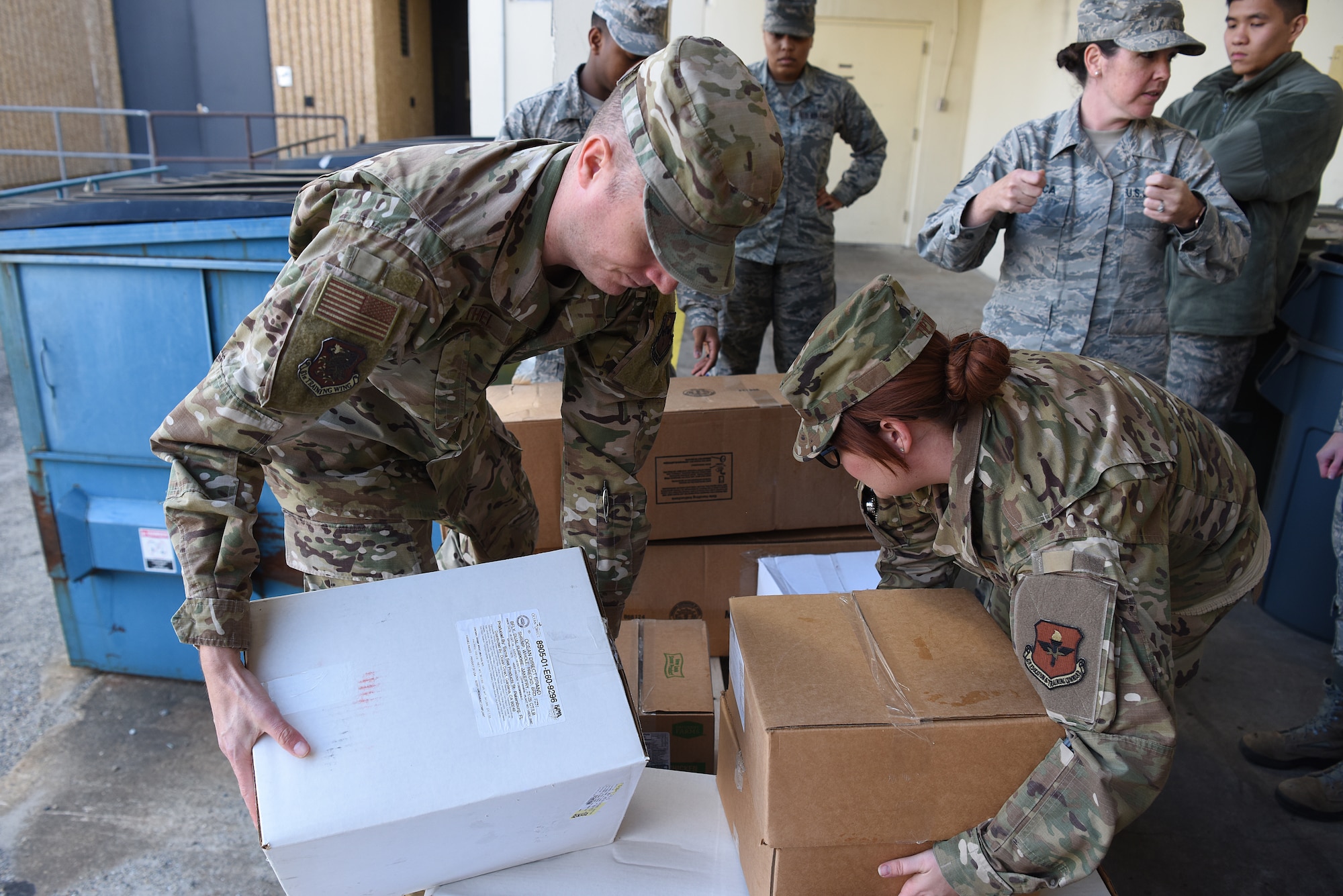 Airmen from the 81st Medical Group palletize food outside the Keesler Medical Center at Keesler Air Force Base, Mississippi, Nov. 18, 2019. Team Keesler was able to salvage and donate approximately 3,000 pounds of food to local food banks from a transit aircraft en route to Honduras, which landed at Keesler due to maintenance issues. (U.S. Air Force photo by Senior Airman Suzie Plotnikov)
