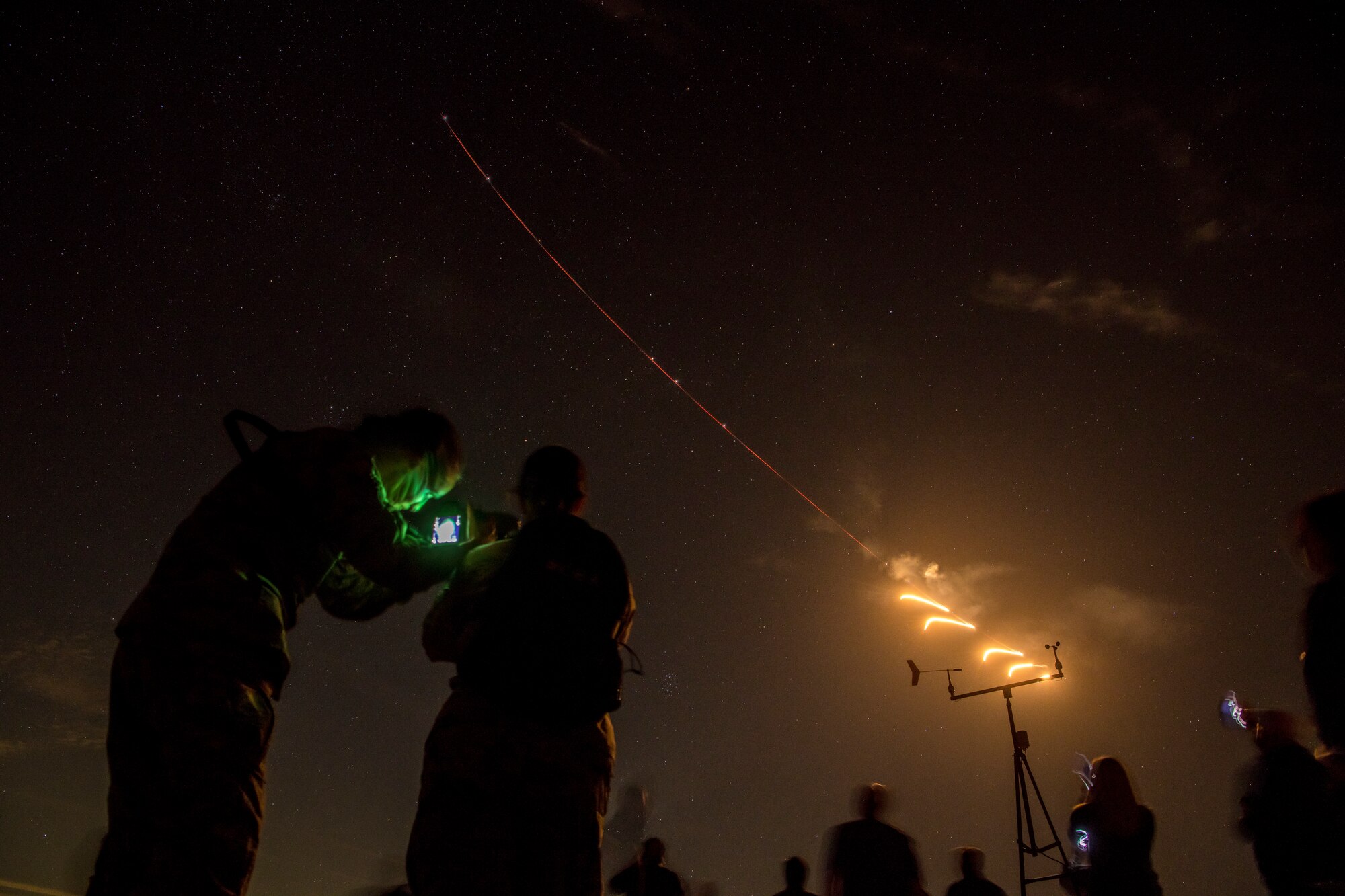 Luke Air Force Base honorary commanders and Airmen watch F-16 Fighting Falcons assigned to the 310th Fighter Squadron, conduct night operations during a tour Nov. 14, 2019, at the Barry M. Goldwater Range, Ariz.