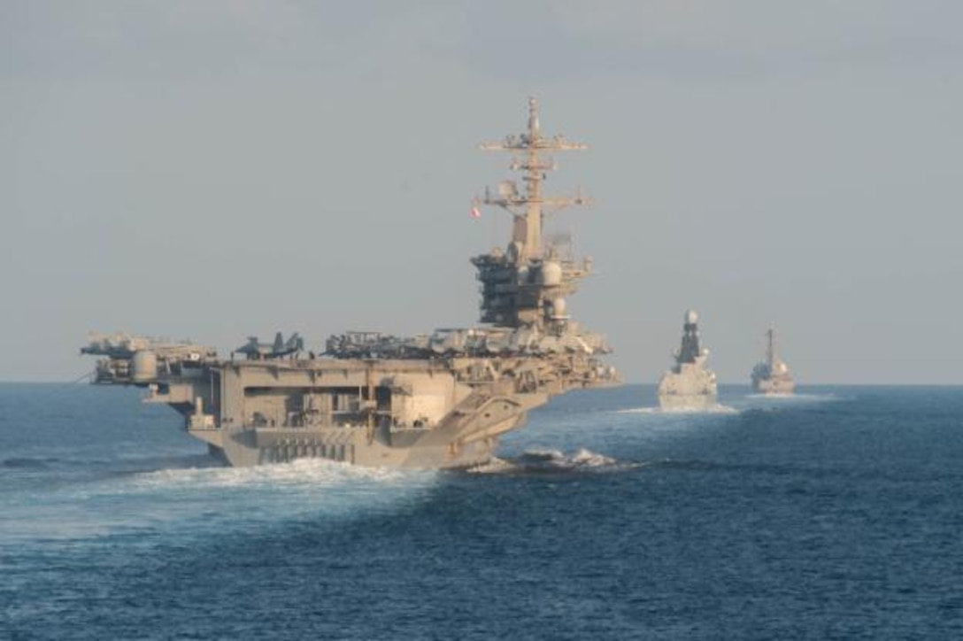 The aircraft carrier USS Abraham Lincoln (CVN 72), left, the air-defense destroyer HMS Defender (D 36) and the guided-missile destroyer USS Farragut (DDG 99) transit the Strait of Hormuz with the guided-missile cruiser USS Leyte Gulf (CG 55). Leyte Gulf is deployed to the U.S. 5th Fleet area of operations in support of naval operations to ensure maritime stability and security in the Central Region, connecting the Mediterranean and Pacific through the Western Indian Ocean and three strategic choke points.