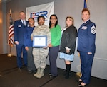 Col. Terry W. McClain, 433rd Airlift Wing commander; Lauren Earl, counselor; Airman 1st Class Shamia Coleman, 433rd Medical Squadron public health; Kellye Jackson, counselor; Monica Garcia, director of guidance and counseling; and Chief Master Sgt. Shana C. Cullum, 433rd AW command chief, pause for a moment following the ESGR Salute to Employers Awards luncheon Nov. 13, 2019 in San Antonio.