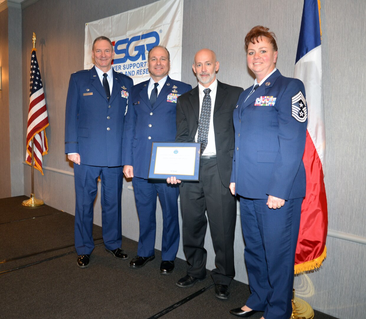 Col. Terry W. McClain, 433rd Airlift Wing commander; Chief Master Sgt. Andrew Branning, 433rd AW administration functional manager; Mark Middleton, CloudWave VIP of cloud services; and Chief Master Sgt. Shana C. Cullum, 433rd AW command chief, pause for a moment following the ESGR Salute to Employers Awards luncheon Nov. 13, 2019 in San Antonio.