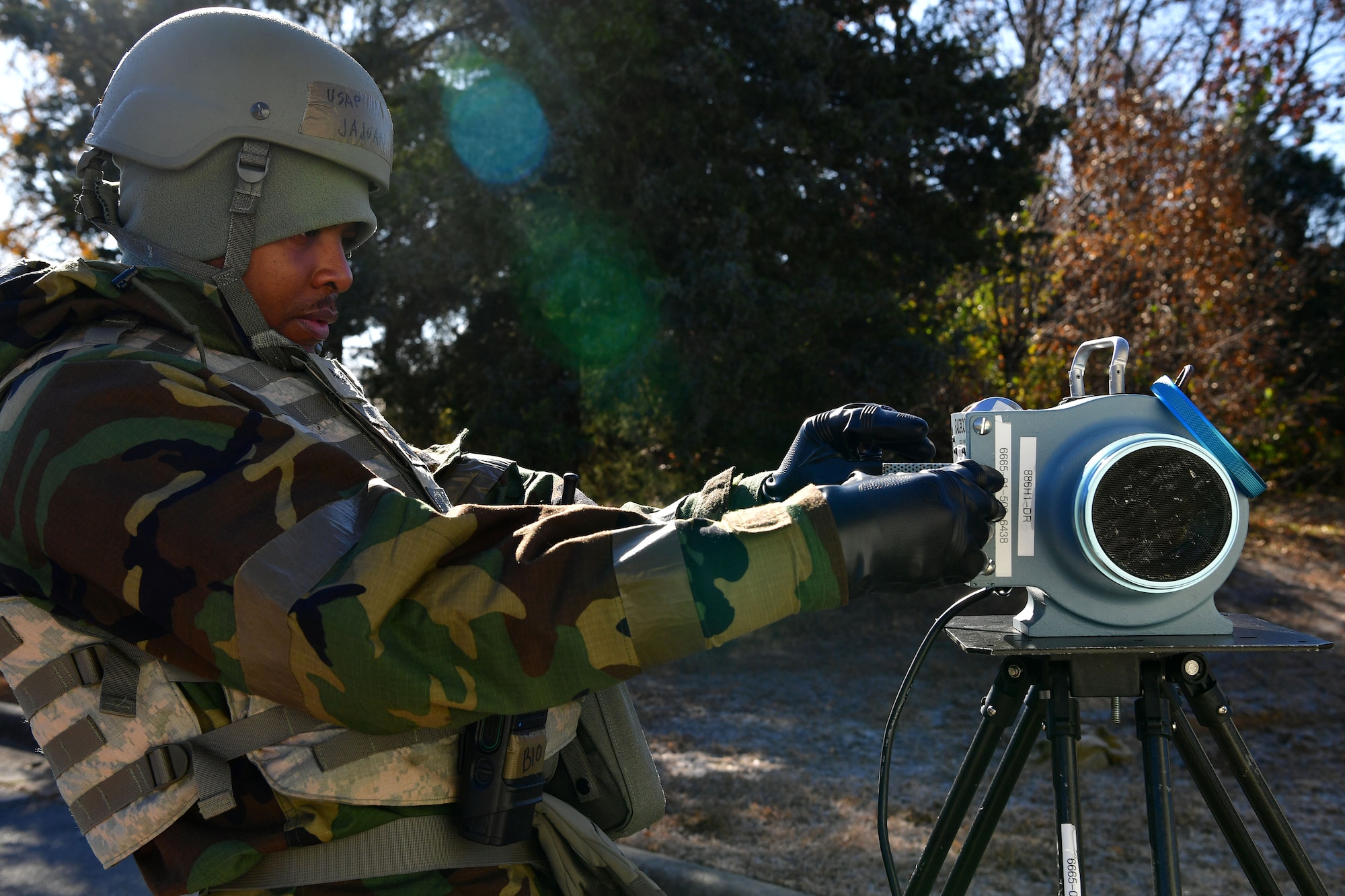 An airman uses a tool to detect radiation