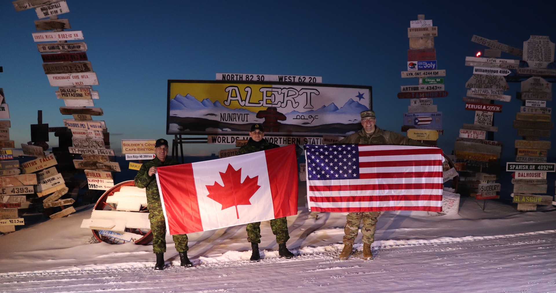 CANADIAN FORCES STATION ALERT, Canada – Col. Timothy Bos, right, 821st Air Base Group commander, Royal Canadian Air Force Maj. Loay El-Beltagy, center, acting commanding officer at Canadian Forces Station Alert; and RCAF Master Warrant Officer Dwayne Fox, left, pose for a photo Oct. 30, 2019 at CFS Alert.  The relationship between the two military bases goes back to 1956 when Operation BOXTOP began to enable the transport of critical resources to the northernmost inhabited place in the world. (U.S. Air Force courtesy photo)