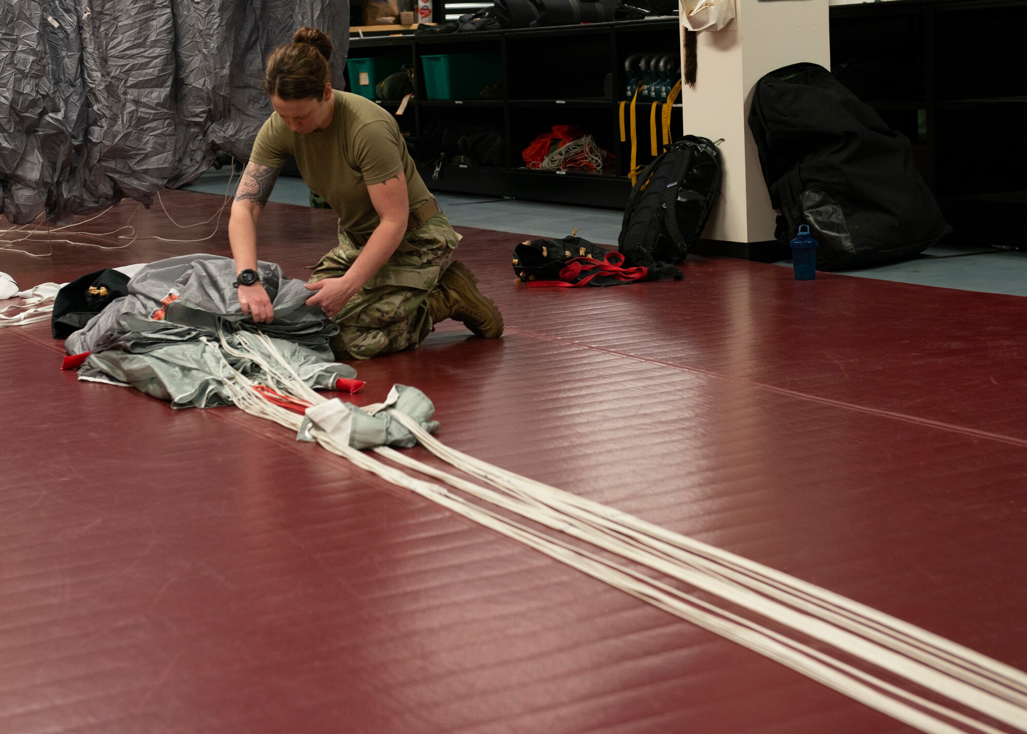 Alaska Air National Guard Staff Sgt. Mel Romero, 176th Operations Support Squadron aircrew flight equipment technician, packs a parachute at Joint Base Elmendorf-Richardson, Alaska, Nov. 14, 2019. The AFE Guardian Angel Section supports Alaska’s rescue mission by preparing parachutes and maintaining the equipment needed to deploy pararescuemen as an emergency response.