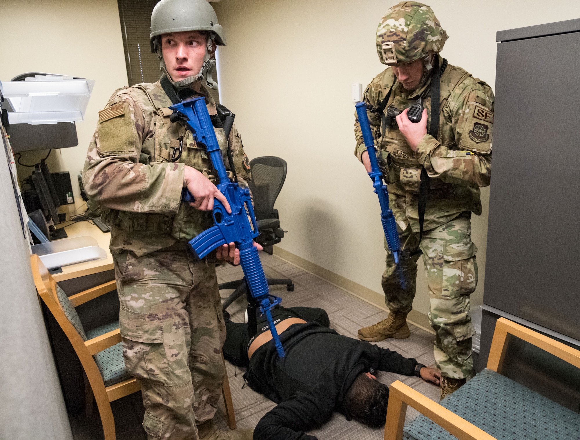 Senior Airman Kale Banyas, 436th Security Forces Squadron response force member, stands watch as Staff Sgt. Robert Wilson, 436th SFS response force leader, makes a radio call after neutralizing a simulated active shooter at the 436th Medical Group clinic during Exercise DORMAR Nov. 12, 2019, at Dover Air Force Base, Del. Simulated active shooter Senior Airman Christian Dungca, 436th SFS response force member, walked around the clinic, inflicting simulated injuries and casualties. (U.S. Air Force photo by Roland Balik