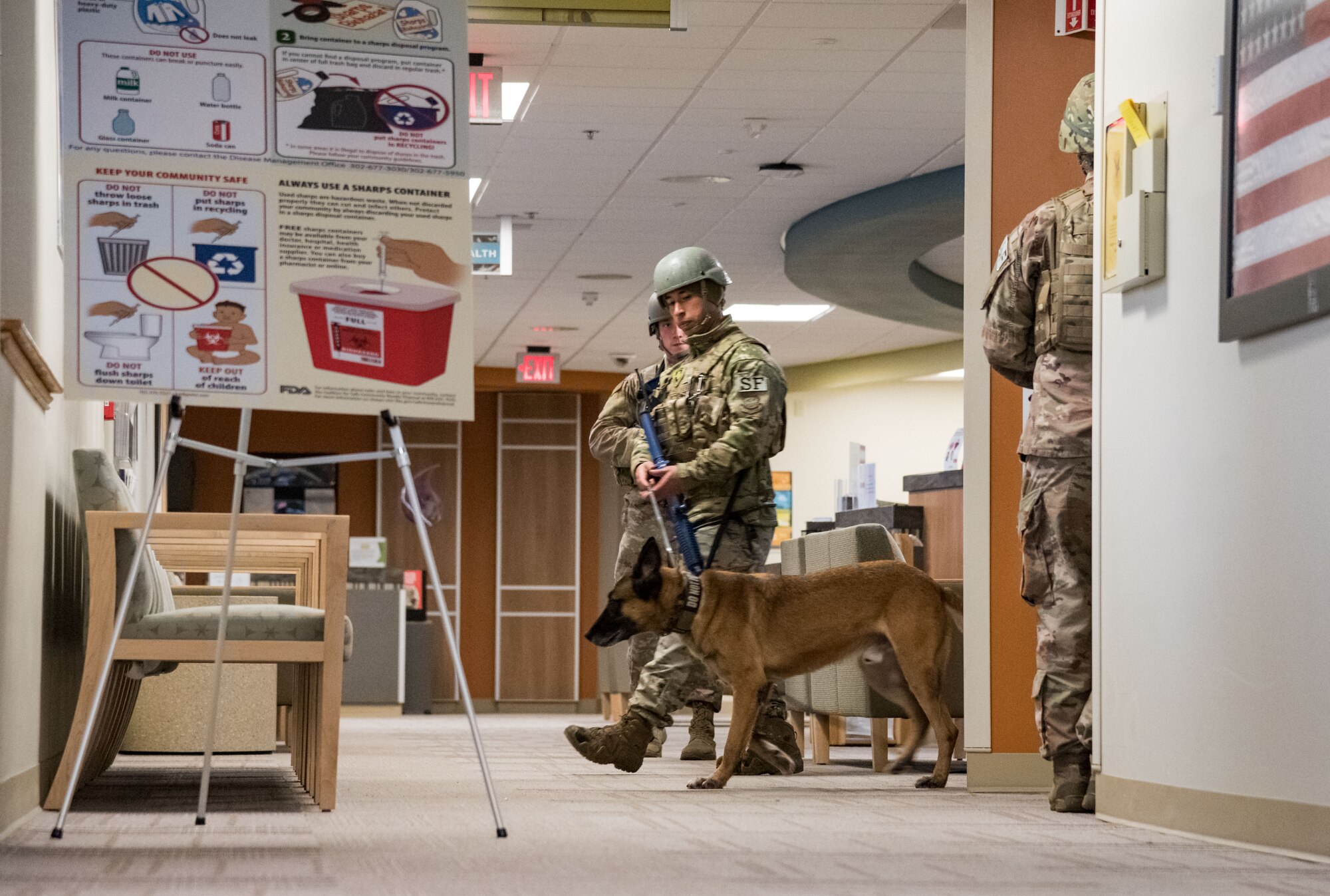 Staff Sgt. Edwin Arguetahernandez, 436th Security Forces Squadron military working dog handler, and MWD Johny, search the 436th Medical Group clinic for simulated victims during a simulated active shooter scene as part of Exercise DORMAR Nov. 12, 2019, at Dover Air Force Base, Del. Two 436th SFS response force members portrayed active shooters who mortally wounded clinic personnel. (U.S. Air Force photo by Roland Balik)
