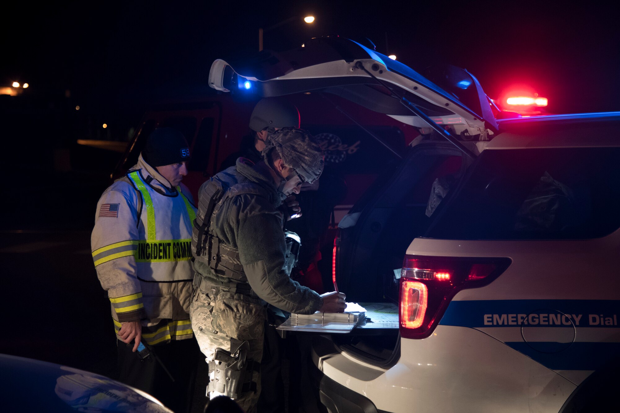 Incident command Airmen strategize during a suspicious package scenario for exercise Dover Operational Readiness for a Multi-domain Agile Response at Dover Air Force Base, Del., Nov. 13, 2019. The incident command included members from the 436th Security Forces Squadron and 436th Civil Engineer Squadron fire department, who were responsible for establishing cordons and ensuring the safe evacuation of Airmen. (U.S. Air Force photo by Senior Airman Eric M. Fisher)