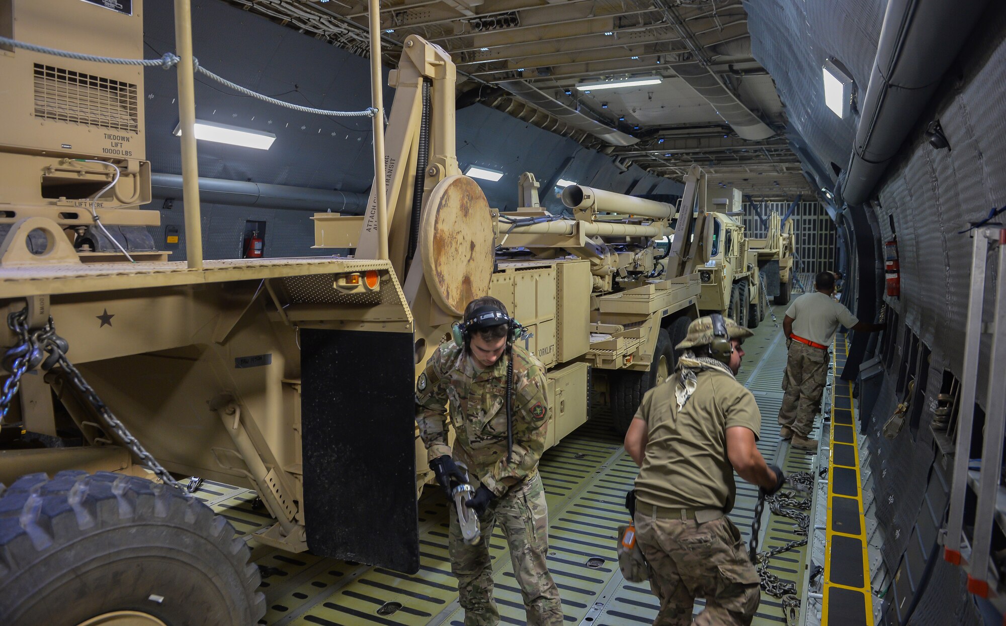 U.S. Air Force Aerial Transportation Specialists with the 378th Aerial Expeditionary Squadron unchain a patriot launching station from a C-5  Galaxy at Prince Sultan Air Base (PSAB), Kingdom of Saudi Arabia (KSA), October 23, 2109.