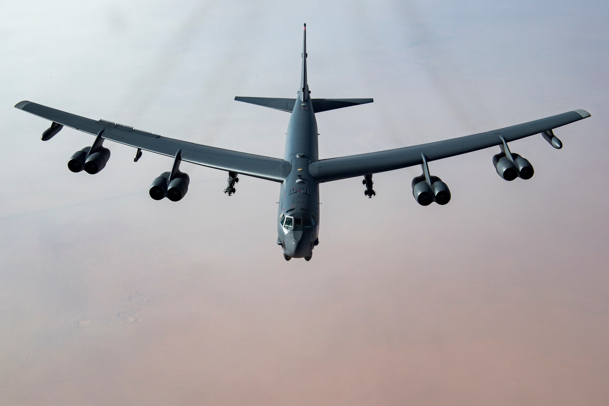 A United States Air Force B-52H Stratofortress, accompanied by four Saudi Arabian F-15C Eagles, conducts a low pass over Prince Sultan Air Base, Saudi Arabia, Nov. 1, 2019.