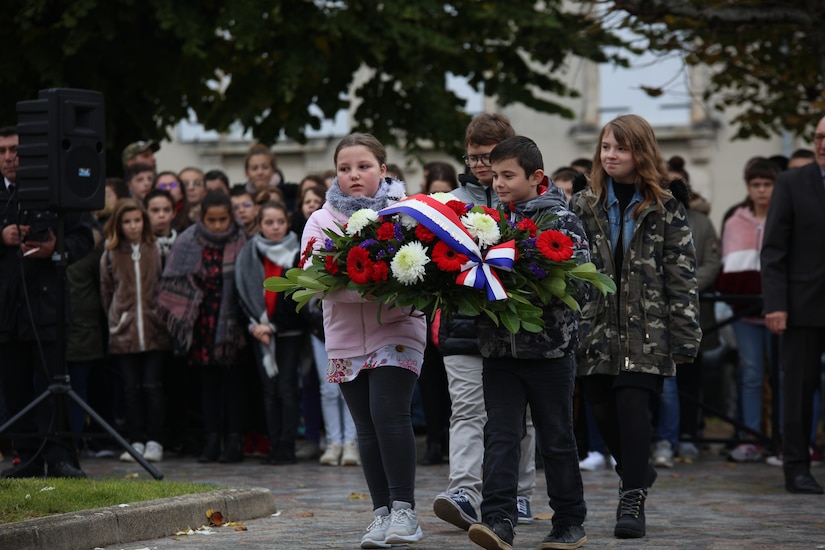 Local school children prepare to lay a wreath during an Armistice Day ceremony Nov. 11, 2019, in Issoudun, France. Villages and cities throughout France commemorated Armistice Day, which marks the armistice signed between the Allies and Germany for the cessation of hostilities in World War I. (U.S. Air Force photo by Master Sgt. John Bloomer)