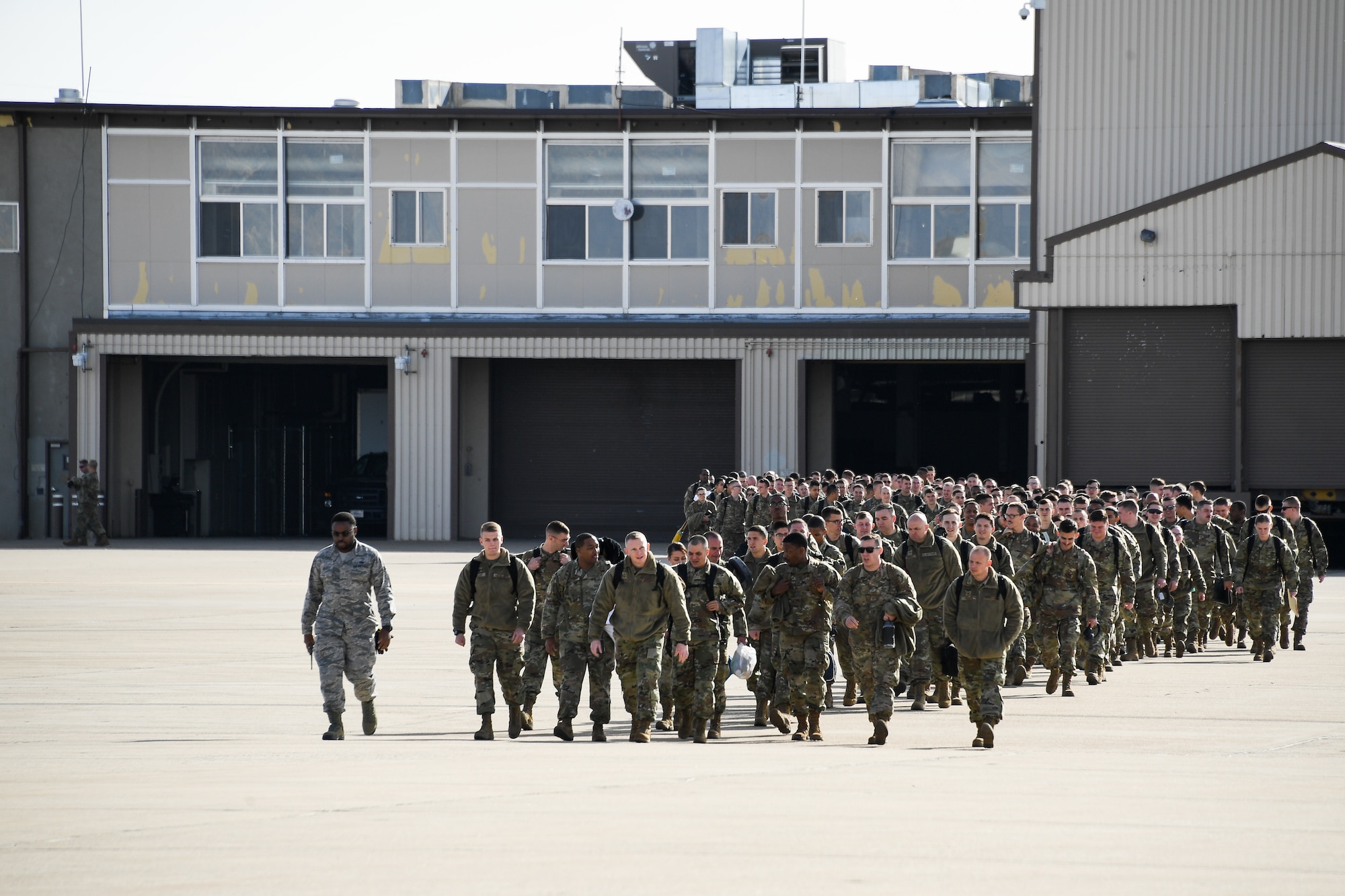Airmen with the 388th and 419th Fighter Wings file out of the Deployment Control Center at Hill Air Force Base, Utah on Nov. 14, 2019. The 34th Fighter Squadron departed Hill for Al Dhafra Air Base, United Arab Emirates, to support the United States Air Force Central Command mission in the MIddle East. The group of deploying Airmen was made up of pilots from the active duty 34th Fighter Squadron and Reserve 466th Fighter Squadron, as well as active duty and Reserve Airmen in the 34th Aircraft Maintenance Unit, and personnel in other support functions. (U.S. Air Force photo by R. Nial Bradshaw)