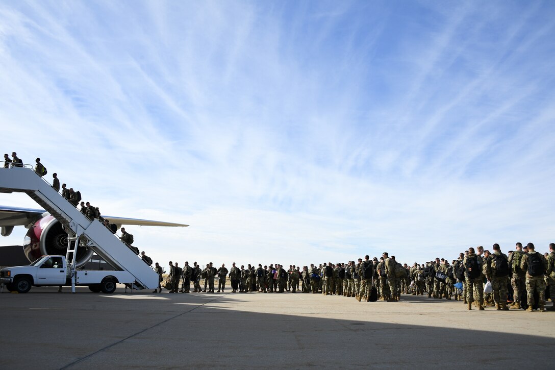 Photo of Airmen boarding a plane.