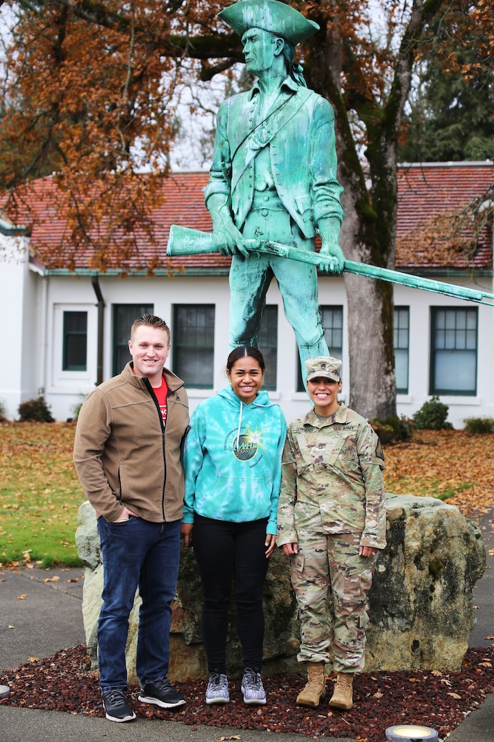 From left to right: PV2 Hunter White, PV2 April Talaiga and Staff Sgt. Marilyn Gerhardt stand with the Minuteman statue at Camp Murray Nov. 17, 2019. The couple joined the Guard together on Oct. 30, 2019.
