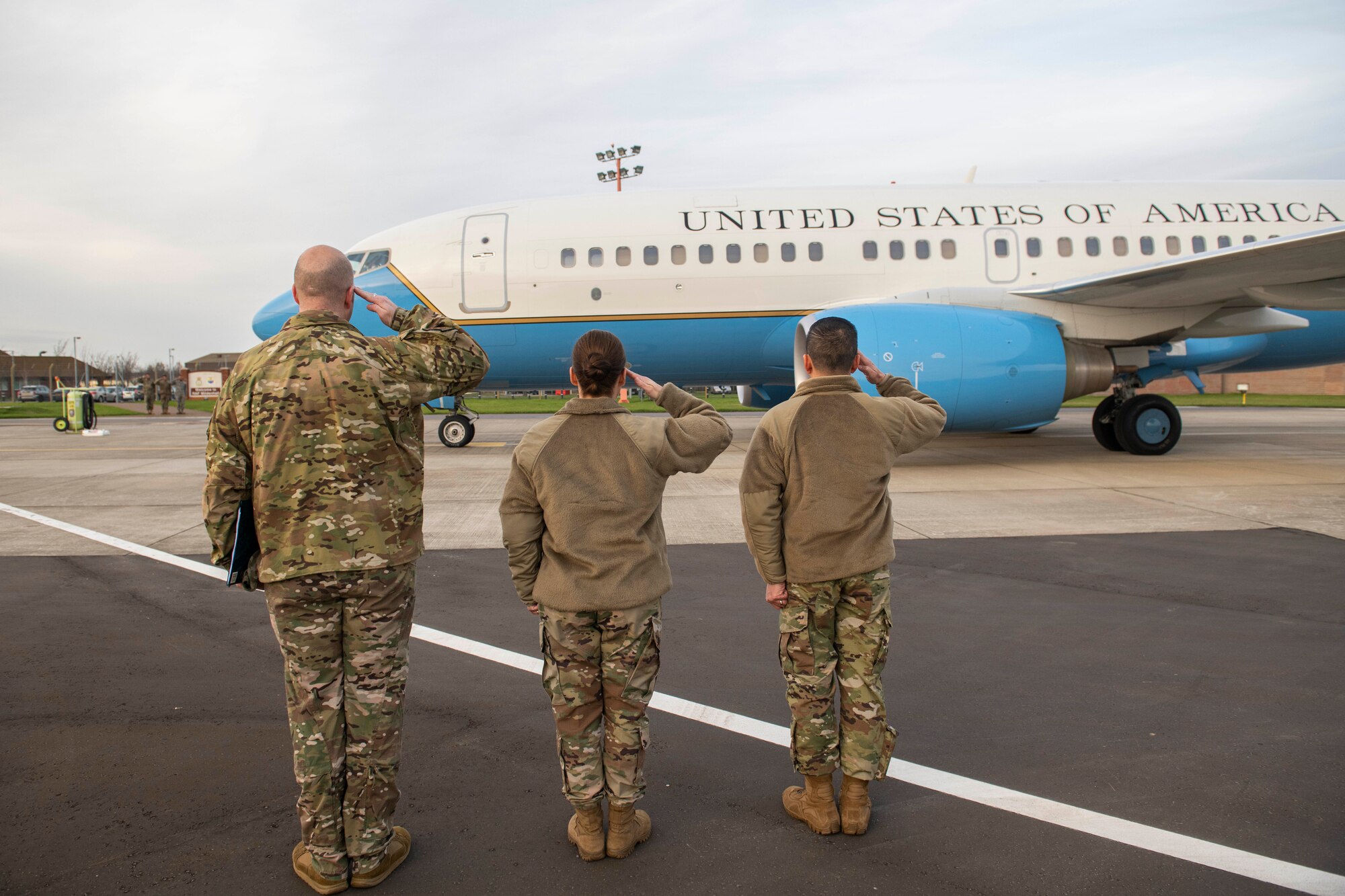 U.S. Air Force Col. Troy Pananon, 100th Air Refueling Wing commander, right, Chief Master Sgt. Kathi Glascock, 100th ARW command chief, middle, and Maj. Thomas Risner, 100th ARW project officer, salute the aircraft carrying U.S. Army Gen. Stephen Lyons, U.S. Transportation Command commander, at RAF Mildenhall, England, Nov. 19, 2019. The 100th ARW directly supports two global combatant commands and is on-call to support three additional commands, including USTRANSCOM. (U.S. Air Force photo by Senior Airman Luke Milano)