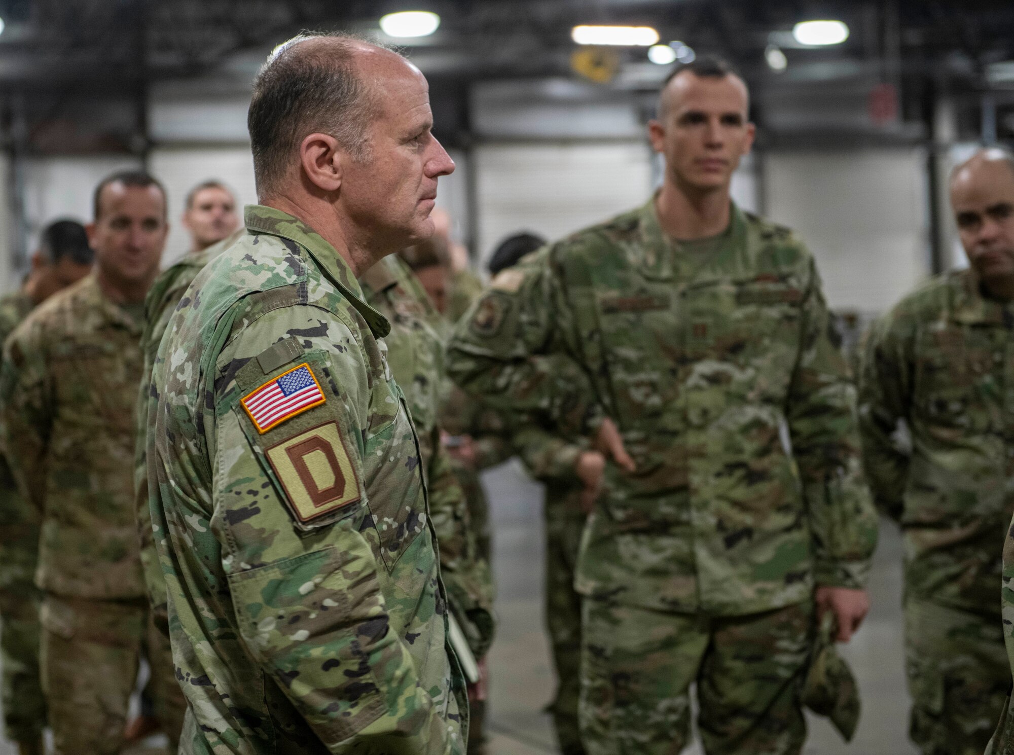 U.S. Army Gen. Stephen Lyons, U.S. Transportation Command commander, speaks with Airmen from the 727th Air Mobility Squadron during his visit at RAF Mildenhall, England, Nov. 19, 2019. The 727th AMS supported 574 USTRANSCOM transient aircraft during Fiscal Year 2019. (U.S. Air Force photo by Senior Airman Luke Milano)