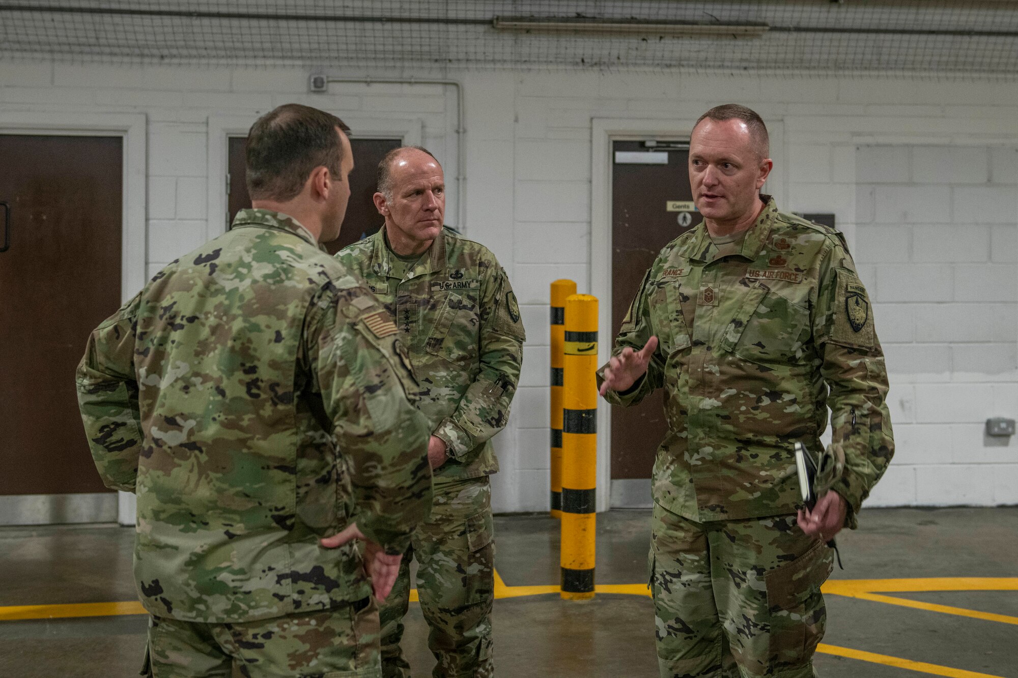 U.S. Air Force Chief Master Sgt. Jason France, U.S. Transportation Command senior enlisted leader, speaks to Maj. Thomas Reynolds, 727th Air Mobility Squadron commander, during a visit to RAF Mildenhall, England, Nov. 19, 2019. France and Gen. Stephen Lyons, USTRANSCOM commander, visited RAF Mildenhall to discuss transportation and support operations and tour 727th AMS facilities. (U.S. Air Force photo by Senior Airman Luke Milano)
