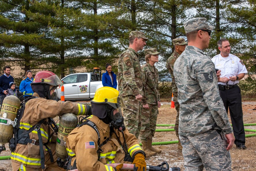 Gen. Maryanne Miller, Air Mobility Command commander, and Chief Master Sgt. Terrence Greene, AMC command chief, visit with 375th Civil Engineer Squadron Fire Protection members during a training exercise at Scott Air Force Base, Ill., Nov. 18, 2019.