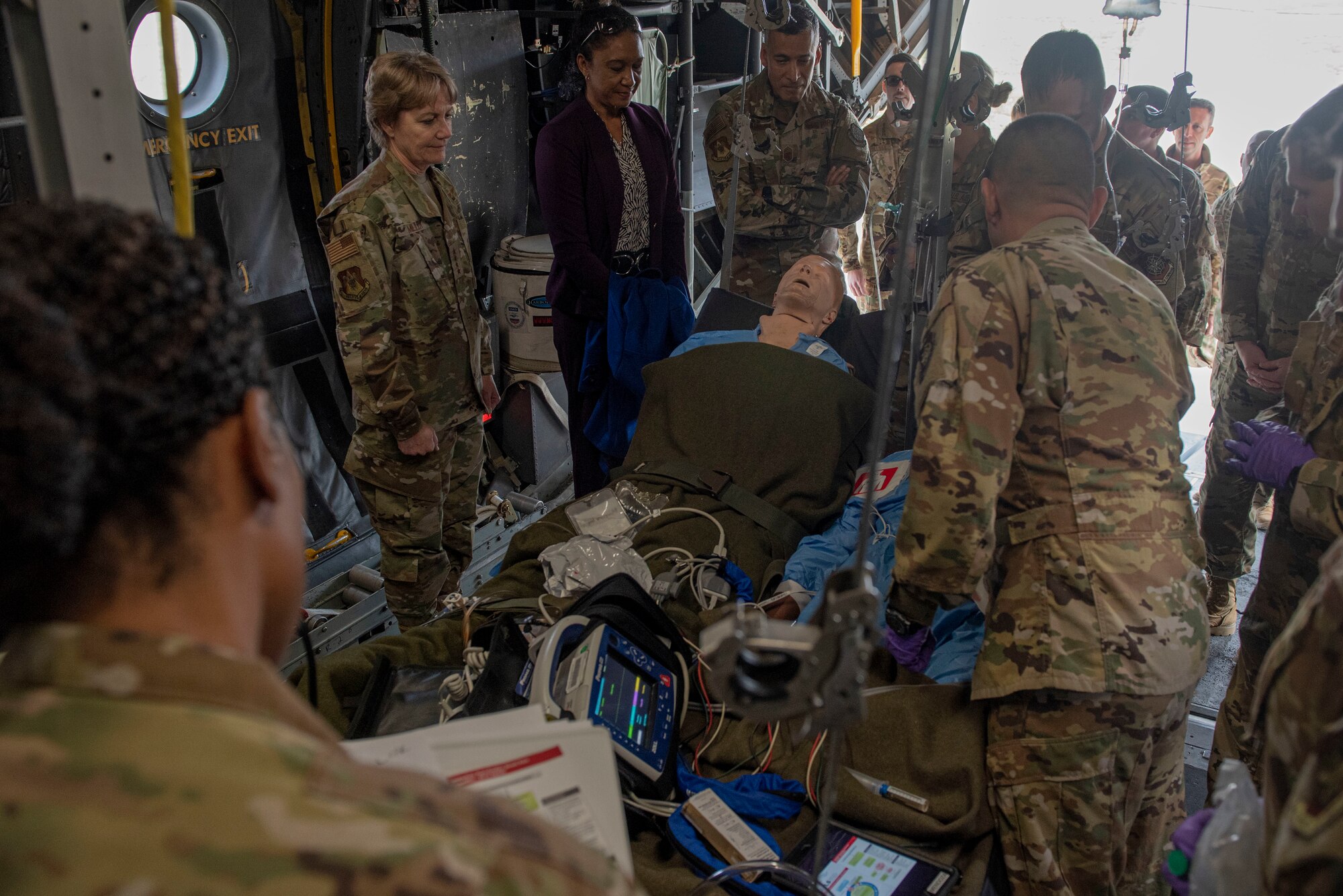 Gen. Maryanne Miller, Air Mobility Command commander, and Chief Master Sgt. Terrence Greene, AMC command chief, observe as members of the 375th Aeromedical Squadron treat a simulated patient suffering from ventricular tachycardia without pulse on board the Fuselage Trainer (FuT) at Scott Air Force Base, Ill., Nov. 18, 2019.