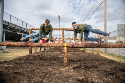 - Two cadets from the Sissonville High School Marine Corps Junior Reserve Officer Training Corps (MCJROTC) demonstrate navigating an obstacle Nov. 19, 2019. (U.S. Army National Guard photo by Bo Wriston)