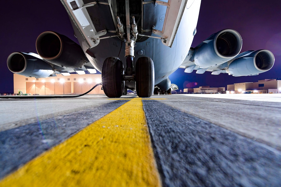 A look underneath a plane as it sits parked.