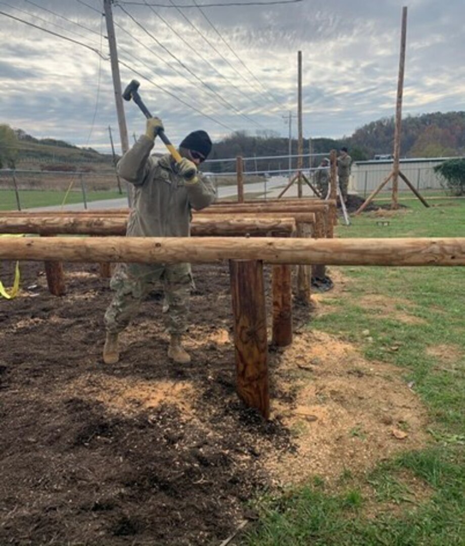 A West Virginia Army National Guard Soldier assigned to the 1092nd Engineer Battalion uses a mallet to drive a post into place to complete an obstacle course for the Sissonville High School Marine Corps Junior Reserve Officer Training Corps. Twelve engineers from the WVANRG completed the obstacle course project in one week as a part of an Innovative Readiness Training (IRT) program.