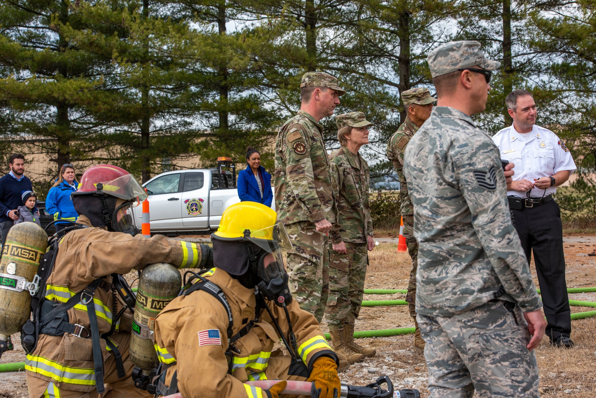 Gen. Maryanne Miller, Air Mobility Command commander, and Chief Master Sgt. Terrence Greene, AMC command chief, visit with 375th Civil Engineer Squadron Fire Protection members during a training exercise at Scott Air Force Base, Ill., Nov. 18, 2019.