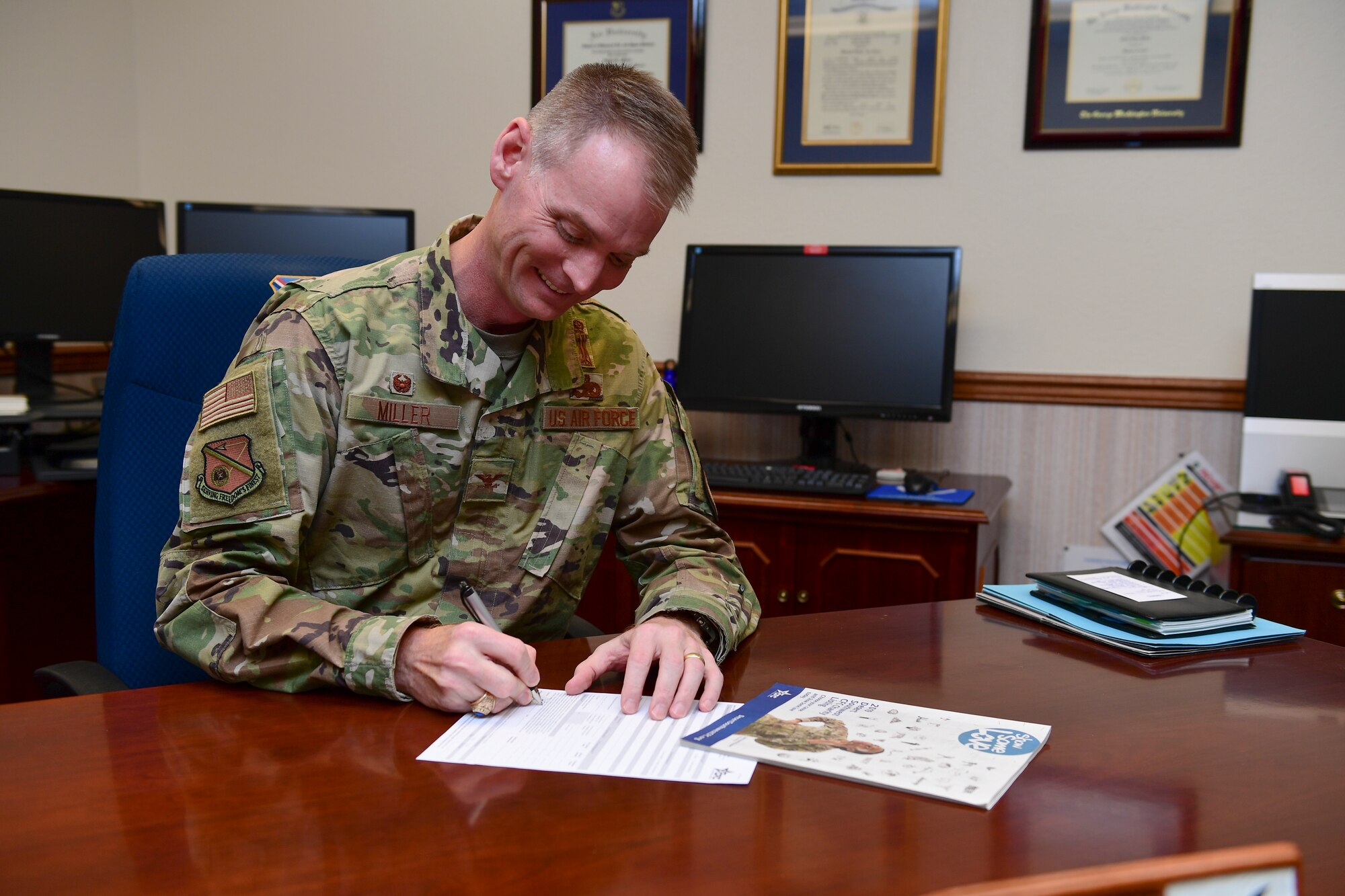 Photo of Air Force members signing paper