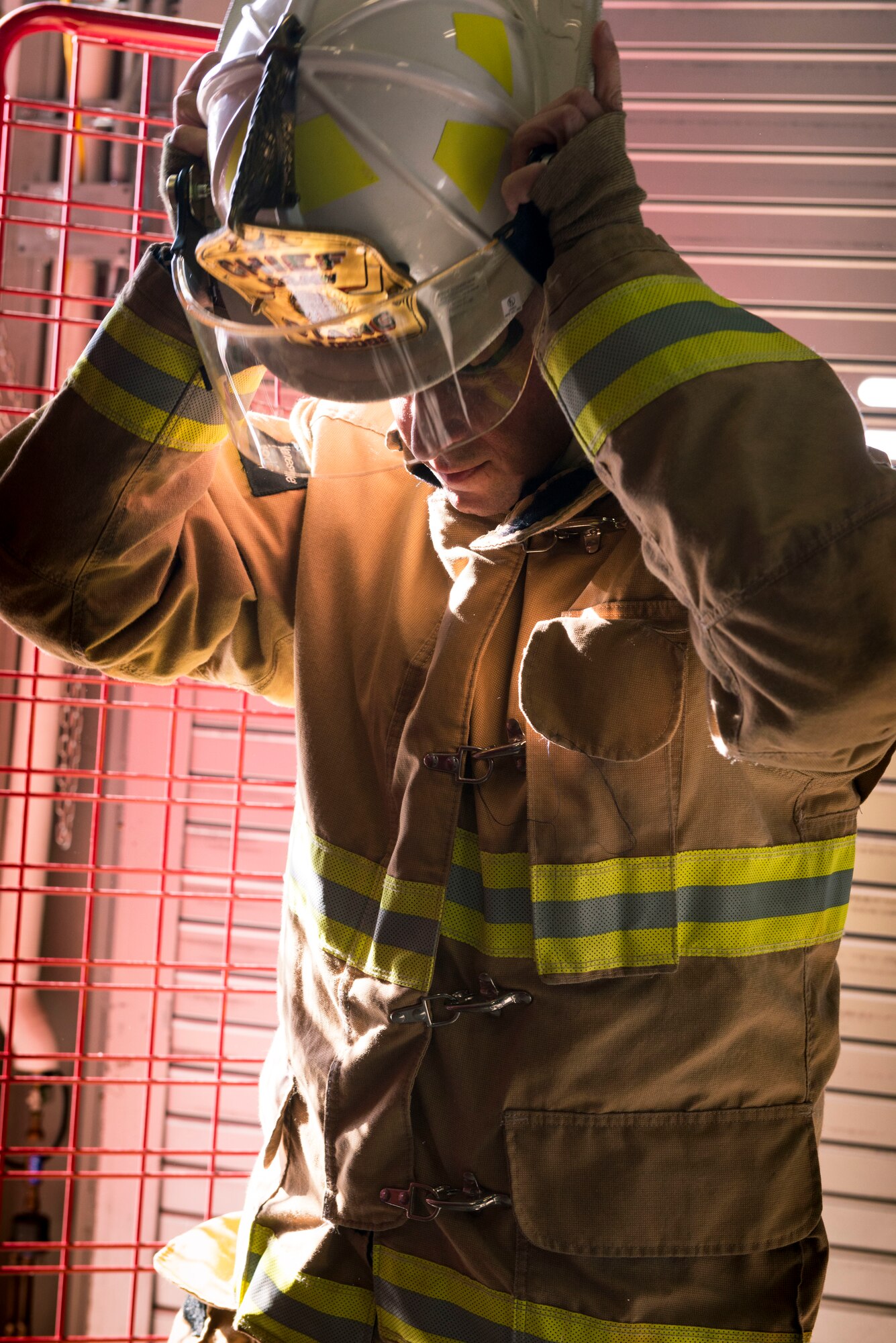 Chief Master Sgt. Robert Cross, Connecticut Air National Guard fire chief, dons his fire helmet at the Bradley Air National Guard Fire Station Nov. 3, 2019 East Granby, Conn. Bradley firefighters provide mutual aid response to the Bradley International Airport firefighters when they receive calls for service. (U.S. Air National Guard photo by Airman 1st Class Chanhda Ly)
