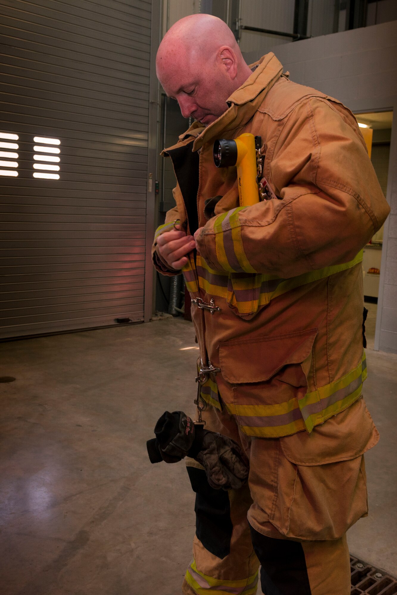 Tech. Sgt. Ronald Avery, firefighter with Bradley Air National Guard Base, adjusts his Personal Protection Equipment (PPE) Nov. 3, 2019 at the Bradley Air National Guard Fire Department, East Granby, Conn. Avery was one of the firefighters from Bradley who responded to the B-17 Flying Fortress crash Oct. 2, 2019. (U.S. Air National Guard photo by Airman 1st Class Chanhda Ly)