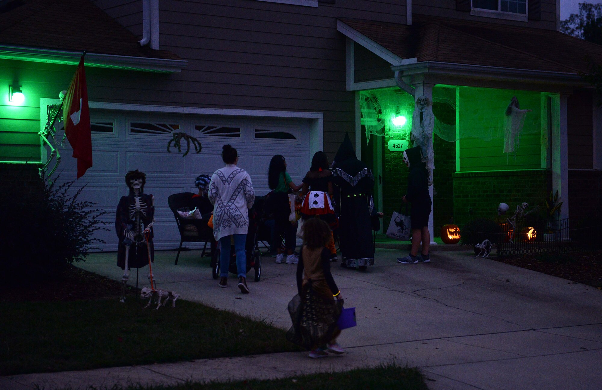 Attendees trick or treat at a decorated house Oct. 27, 2019, on Columbus Air Force Base, Miss. The first jack o’ lanterns were made out of turnips. (U.S. Air Force photo by Airman 1st Class Hannah Bean)