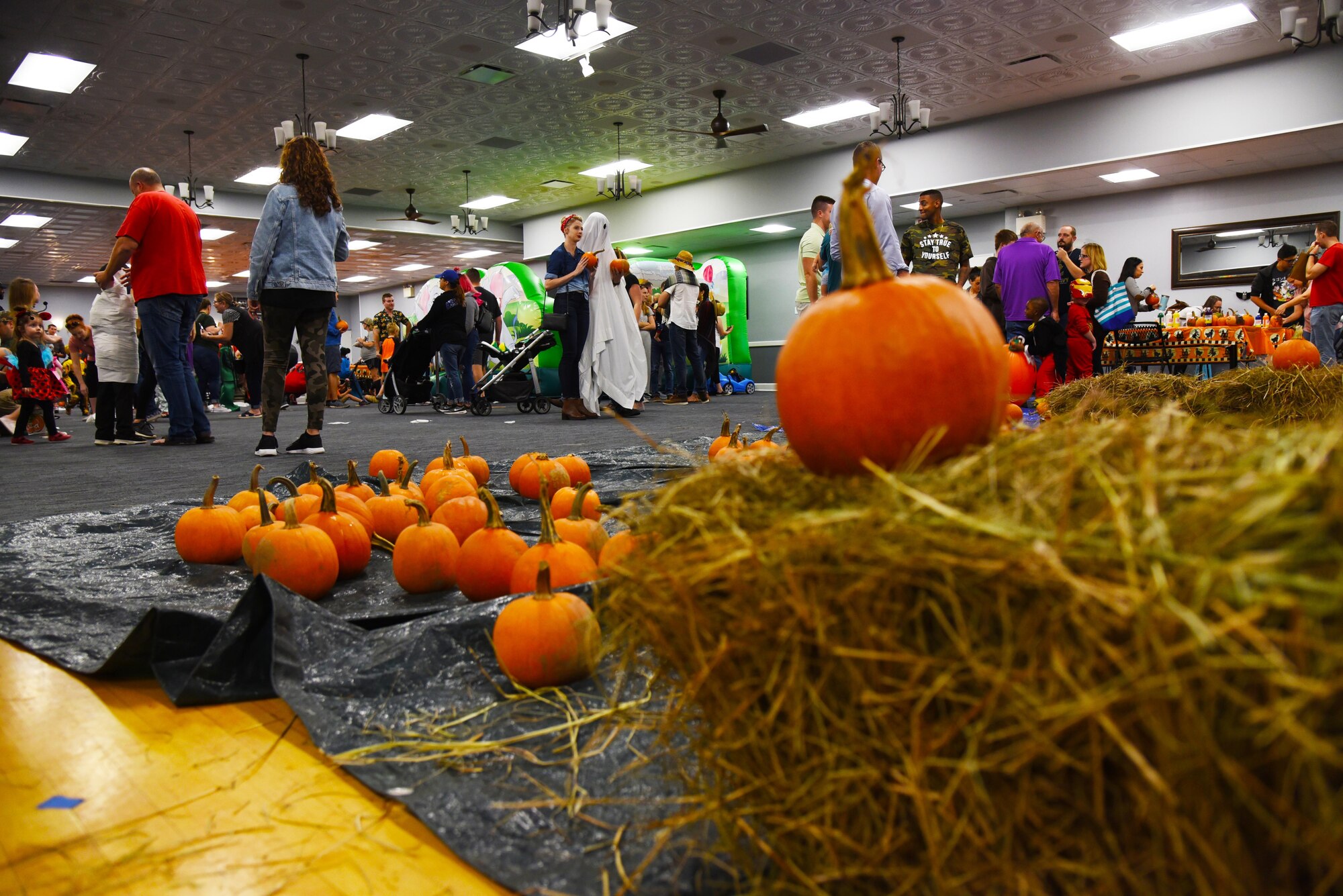 Attendees walk around a pumpkin patch during Boo Fest at the Club Oct. 26, 2019, on Columbus Air Force Base, Miss. According to Guinness World Records, the highest number of lit jack o’ lanterns on display is 30,581 by the City of Keene, New Hampshire in 2013.  (U.S. Air Force photo by Airman 1st Class Jake Jacobsen)