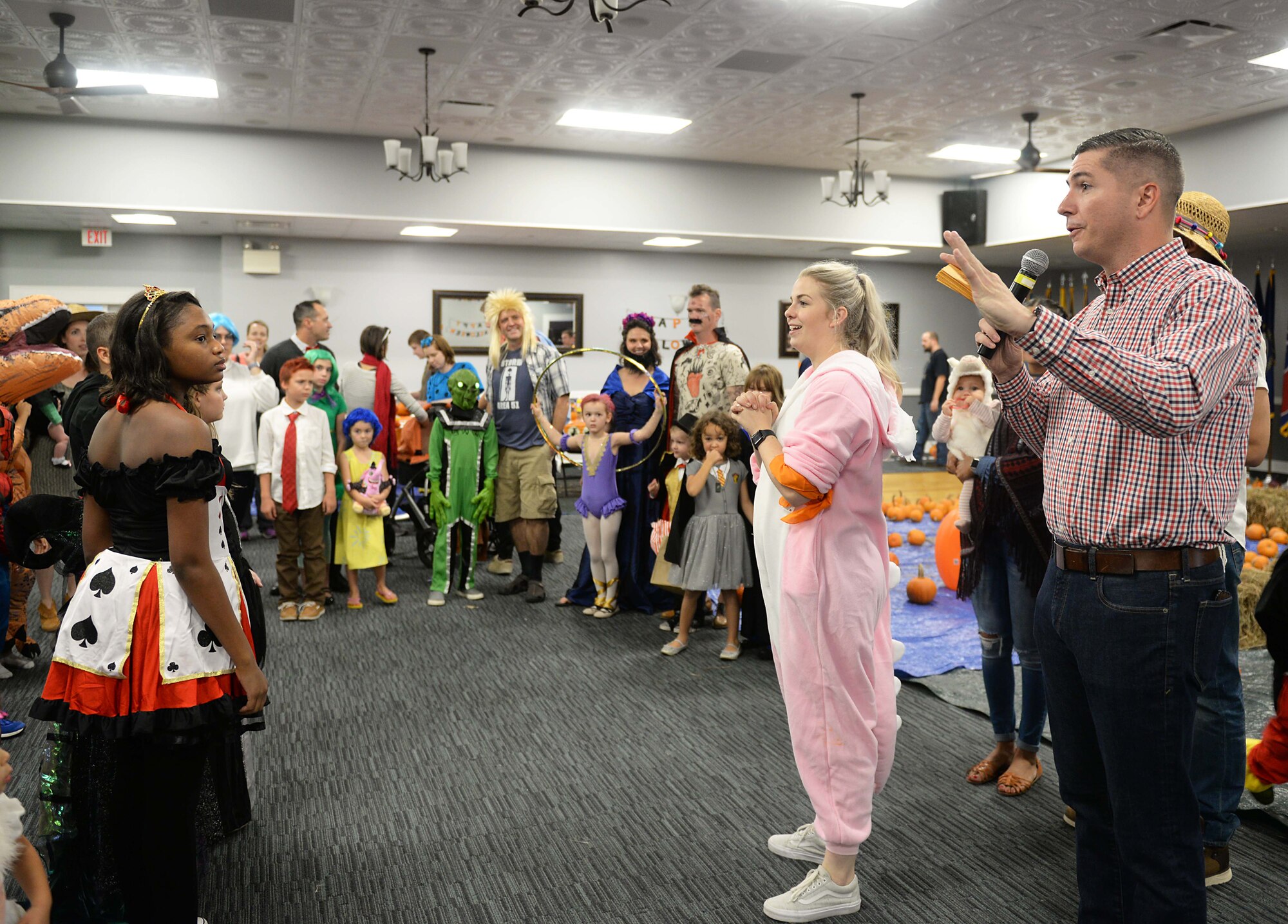 Col. David Fazenbaker, 14th Flying Training Wing vice commander, introduces one set of participants in a costume contest during Boo Fest at the Club Oct. 26, 2019, on Columbus Air Force Base, Miss. Halloween is the second highest grossing commercial holiday after Christmas. (U.S. Air Force photo by Airman 1st Class Hannah Bean)
