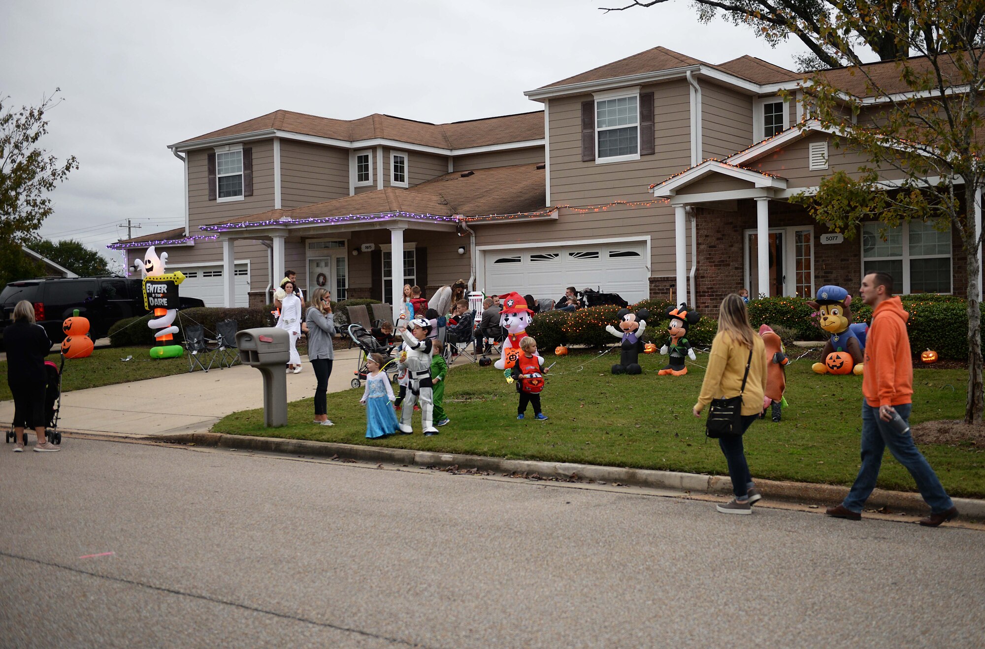 Children, families and friends trick or treat through neighborhoods Oct. 27, 2019, on Columbus Air Force Base, Miss. Halloween originated from an ancient Celtic end-of-harvest festival of Samhain, typically marking the end of the harvest season and the beginning of the winter season. (U.S. Air Force photo by Airman 1st Class Hannah Bean)